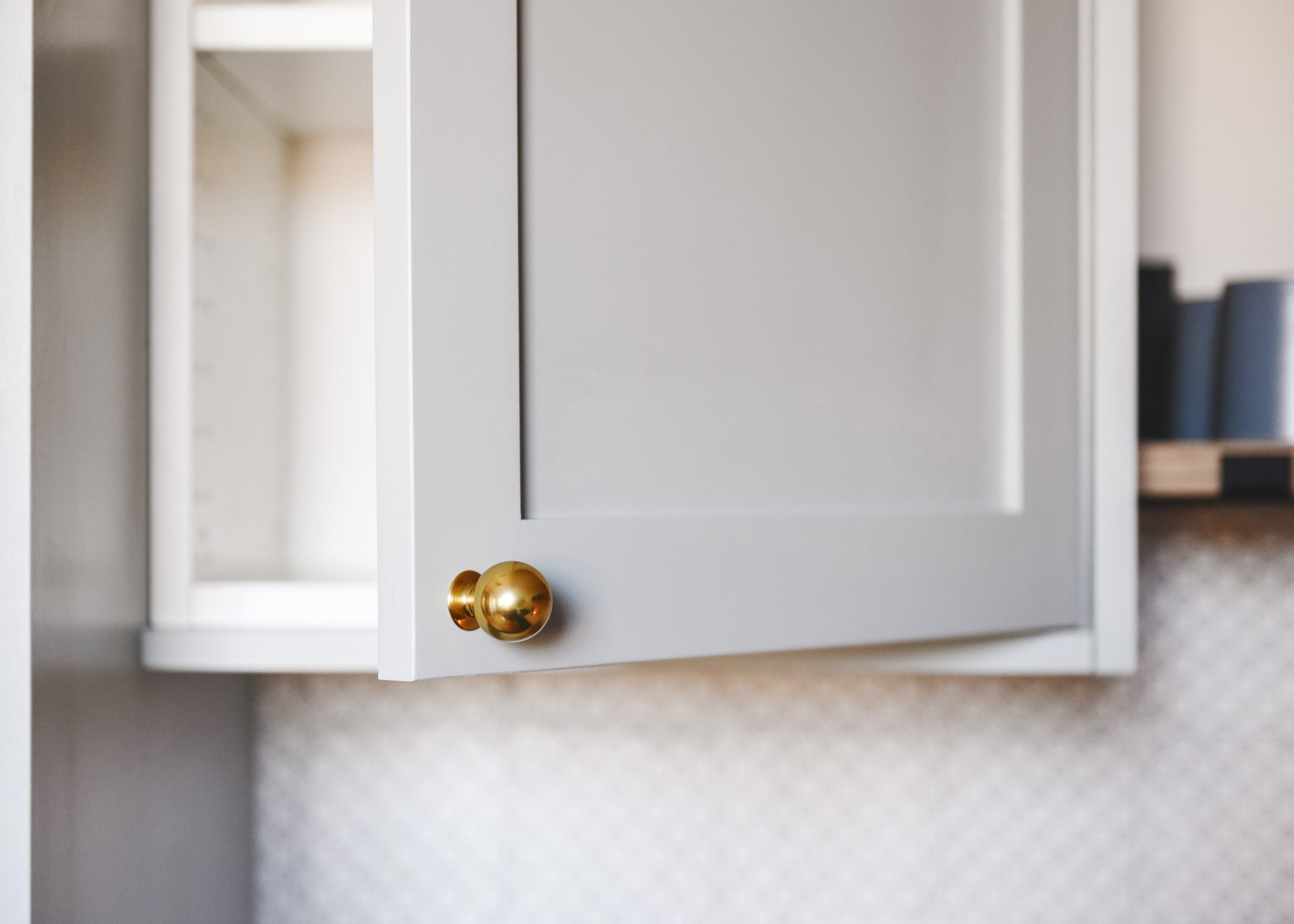 Brass ball knob on a gray-blue cabinet door | via Yellow Brick Home
