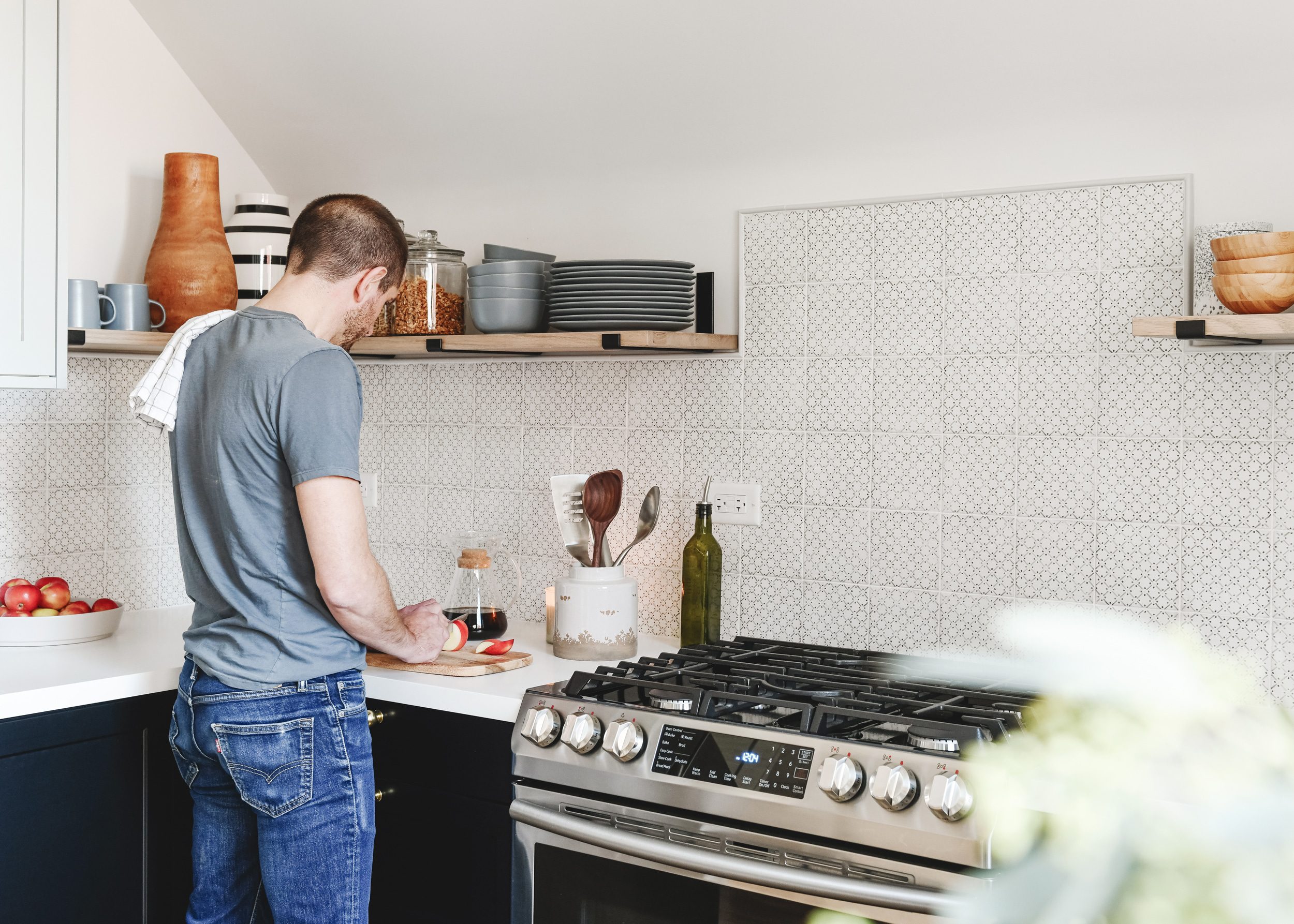 Scott cuts apples on the Formica countertop in our Unit 2 kitchen | via Yellow Brick Home