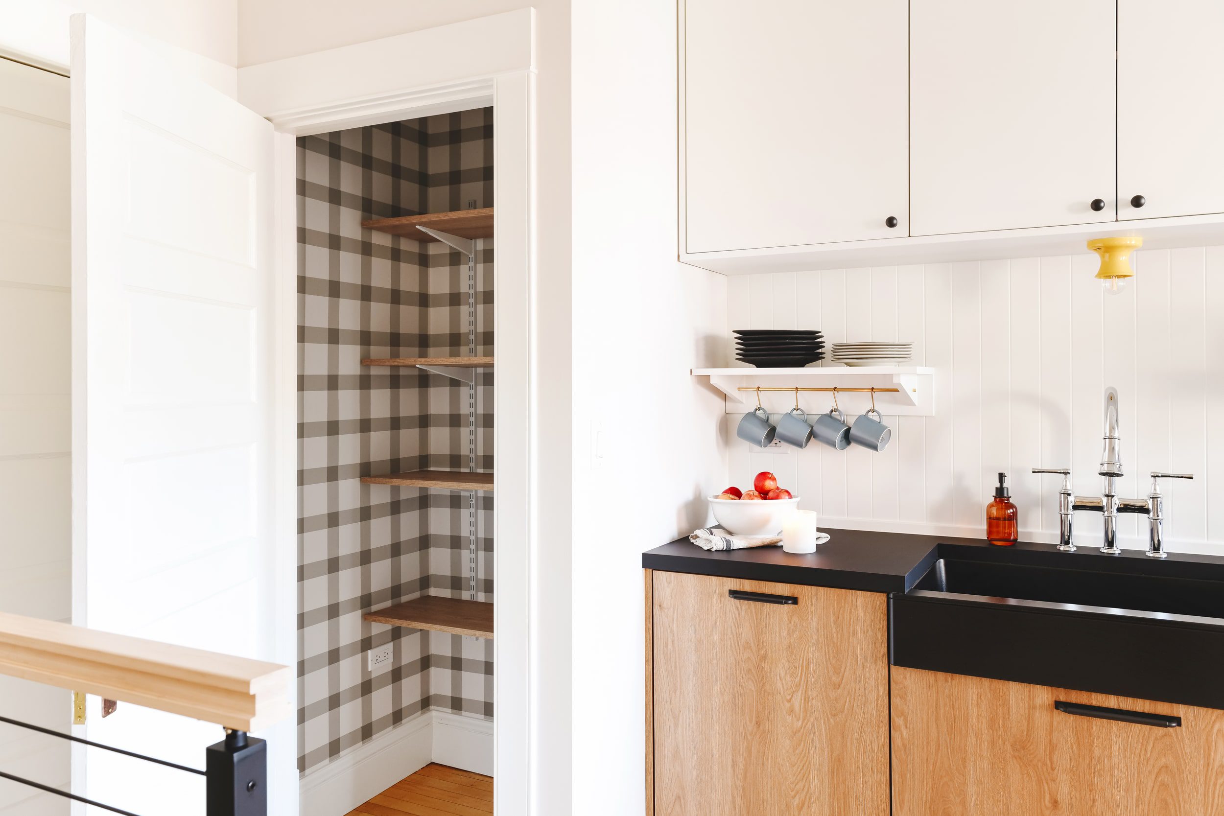 Our Unit 1 two flat kitchen featuring our DIY painted plaid pantry. 