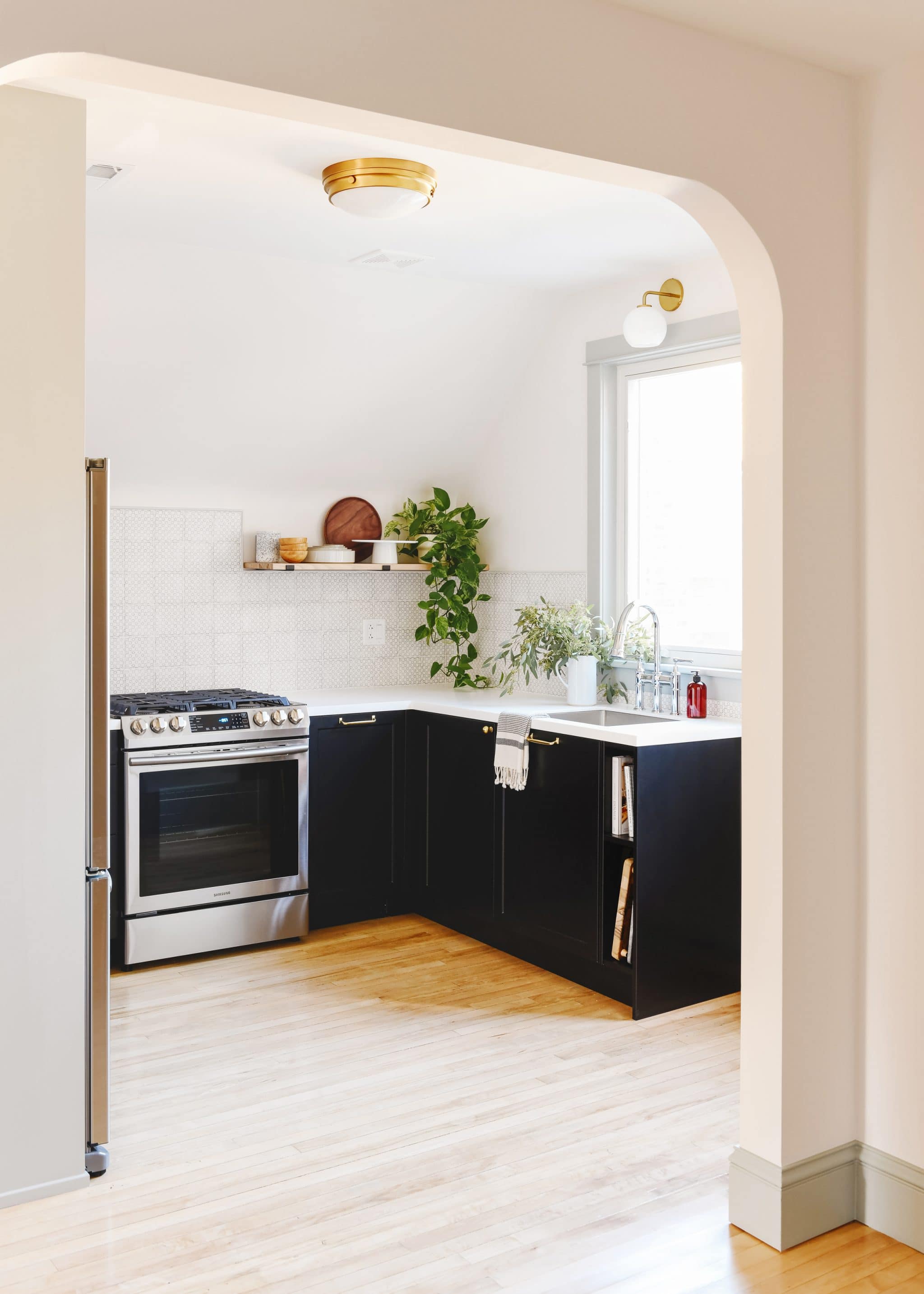 The kitchen in Unit 2 of our two flat was built using IKEA SEKTION cabinets with doors from Semihandmade. The contrast of the black lower cabinets and light countertops was just the pop we were looking for!