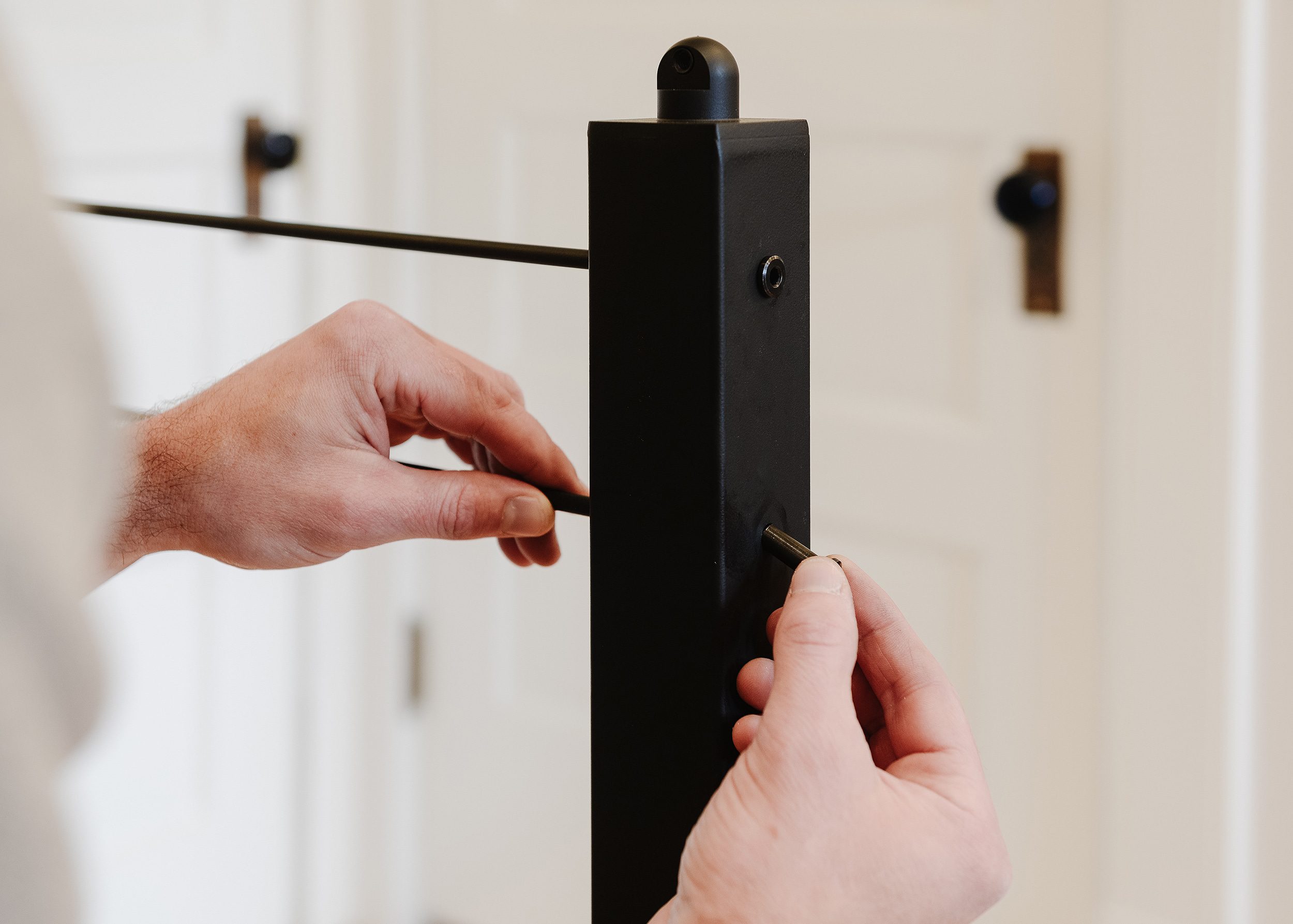 Scott uses a hex key to tighten tension fittings on a railing post.  | via Yellow Brick Home 