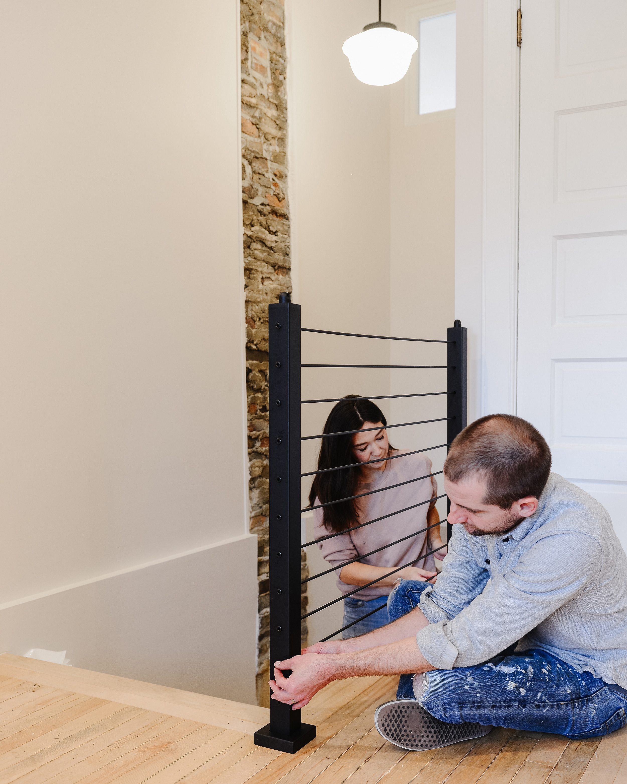 Kim and Scott work together as an unstoppable team to tension the rods on a custom railing installation. | via Yellow Brick Home 