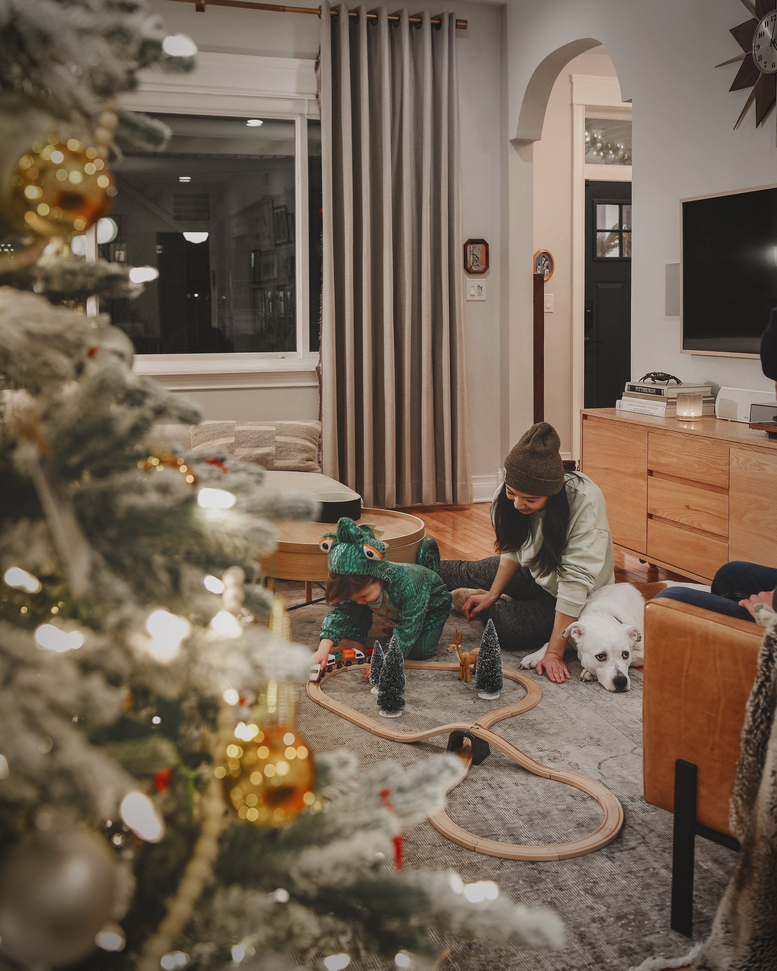 Kim, Lucy and Catfish enjoy creating a Christmas village with train tracks as a part of their holiday time together | via Yellow Brick Home