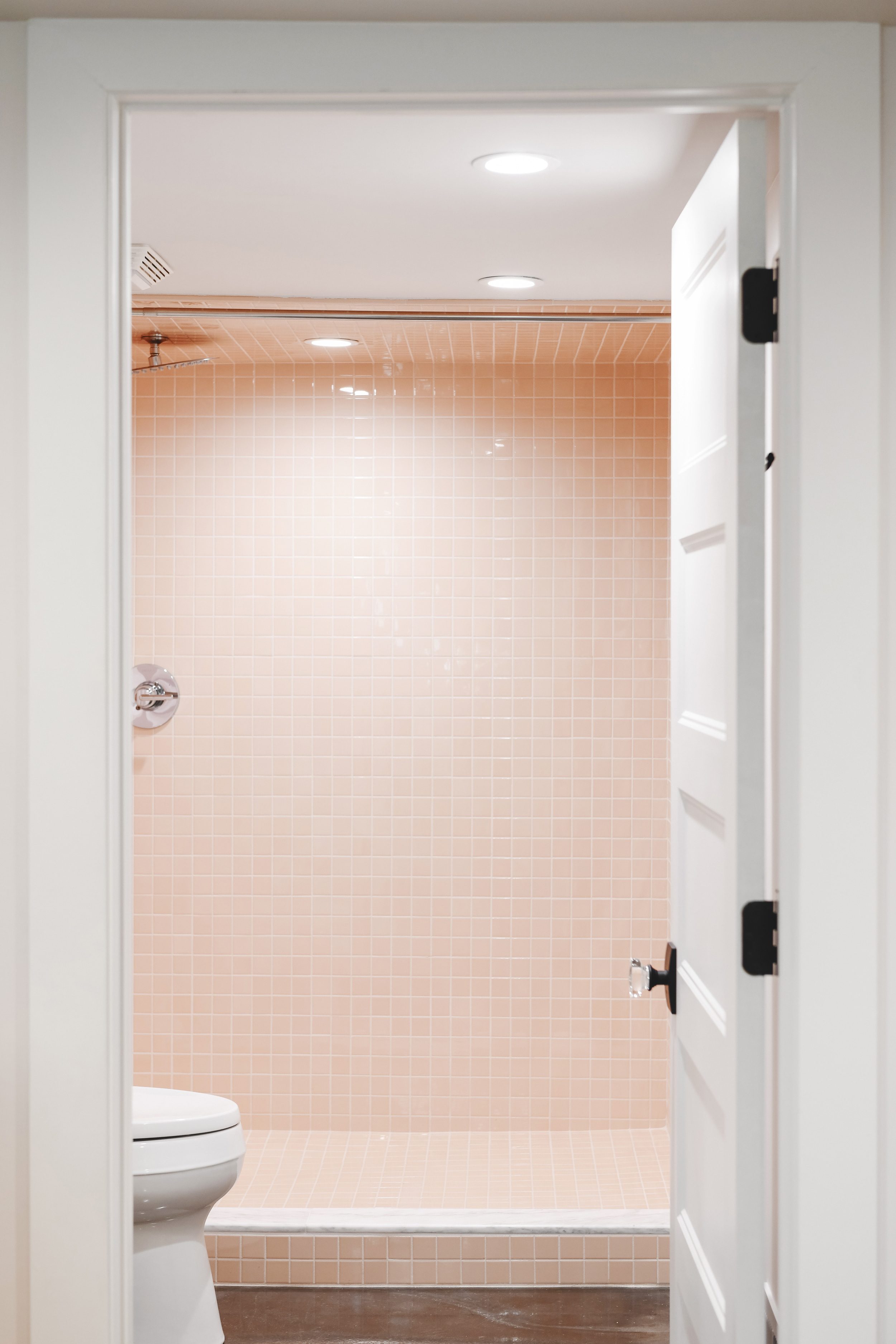 blush and white bathroom with polished concrete floors | Two Flat den bathroom before + after! | via Yellow Brick Home