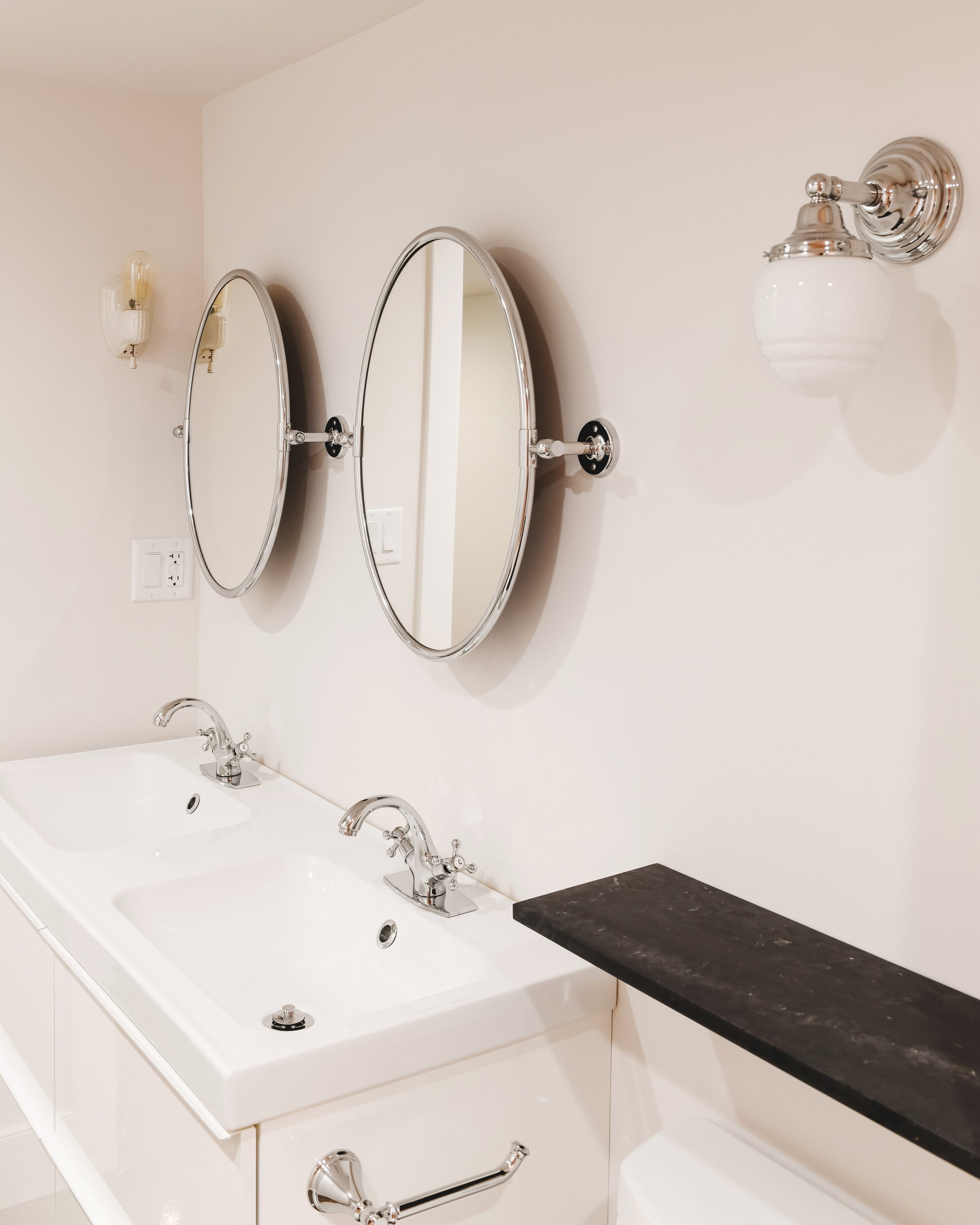 a pair of sconces, faucets and mirrors | Two Flat den bathroom before + after! | via Yellow Brick Home