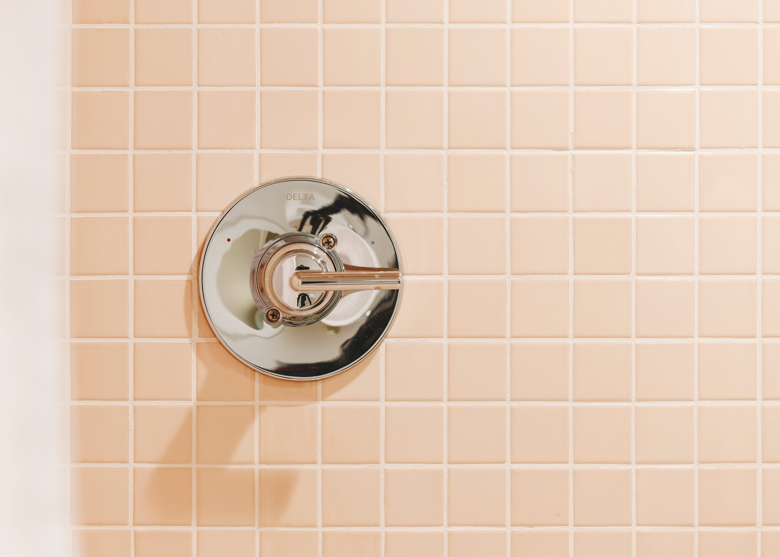 polished chrome trim kit on blush tile | Two Flat den bathroom before + after! | via Yellow Brick Home