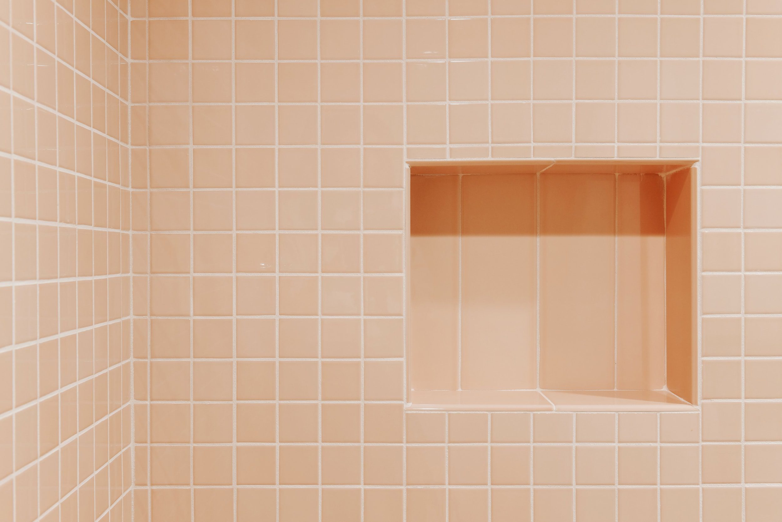 shower niche in a peachy pink standing shower | Two Flat den bathroom before + after! | via Yellow Brick Home