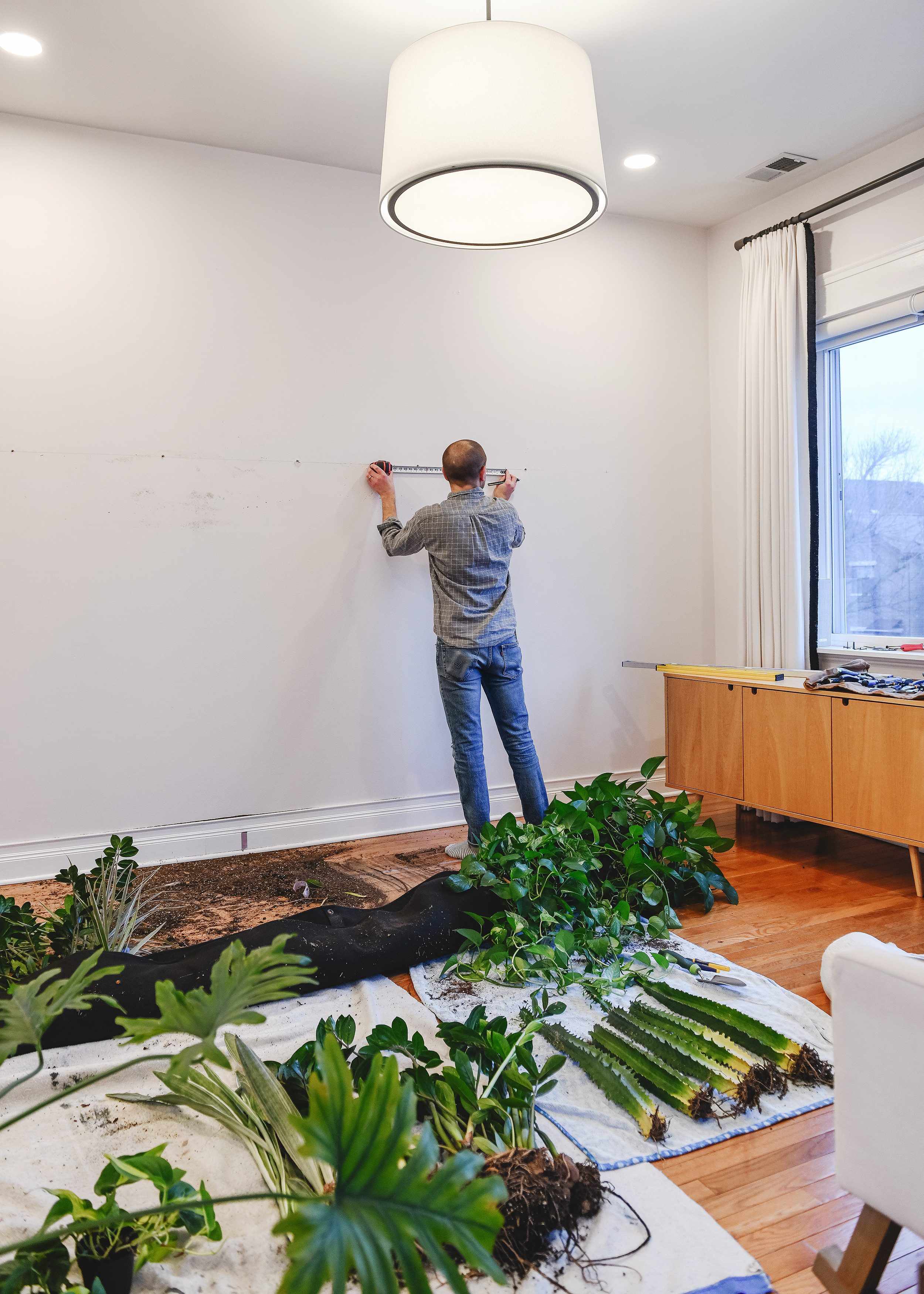 Scott planning for and rearranging a living wall planter | via Yellow Brick Home