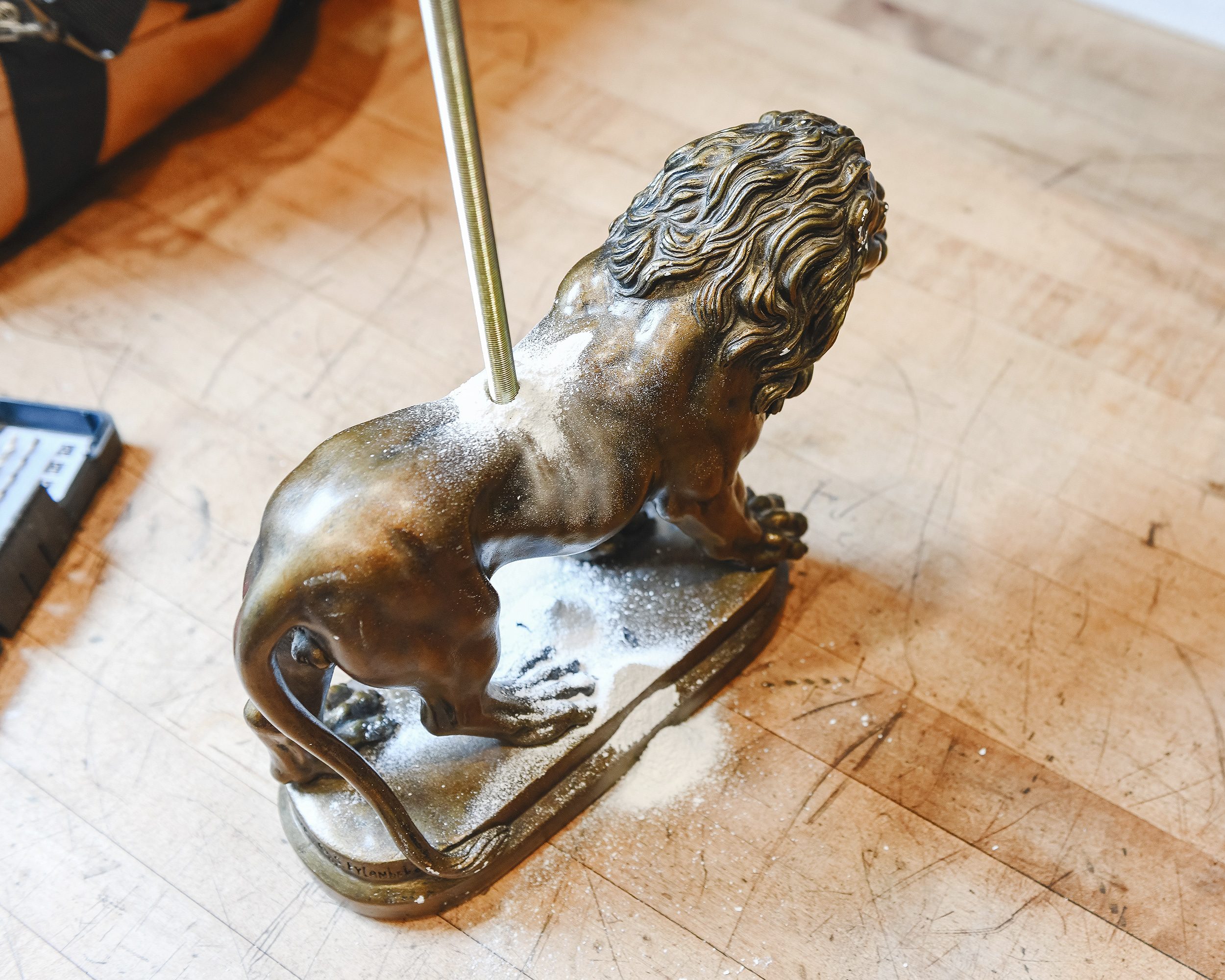 Test-fitting the lamp rod through the lion's body  // via Yellow Brick Home