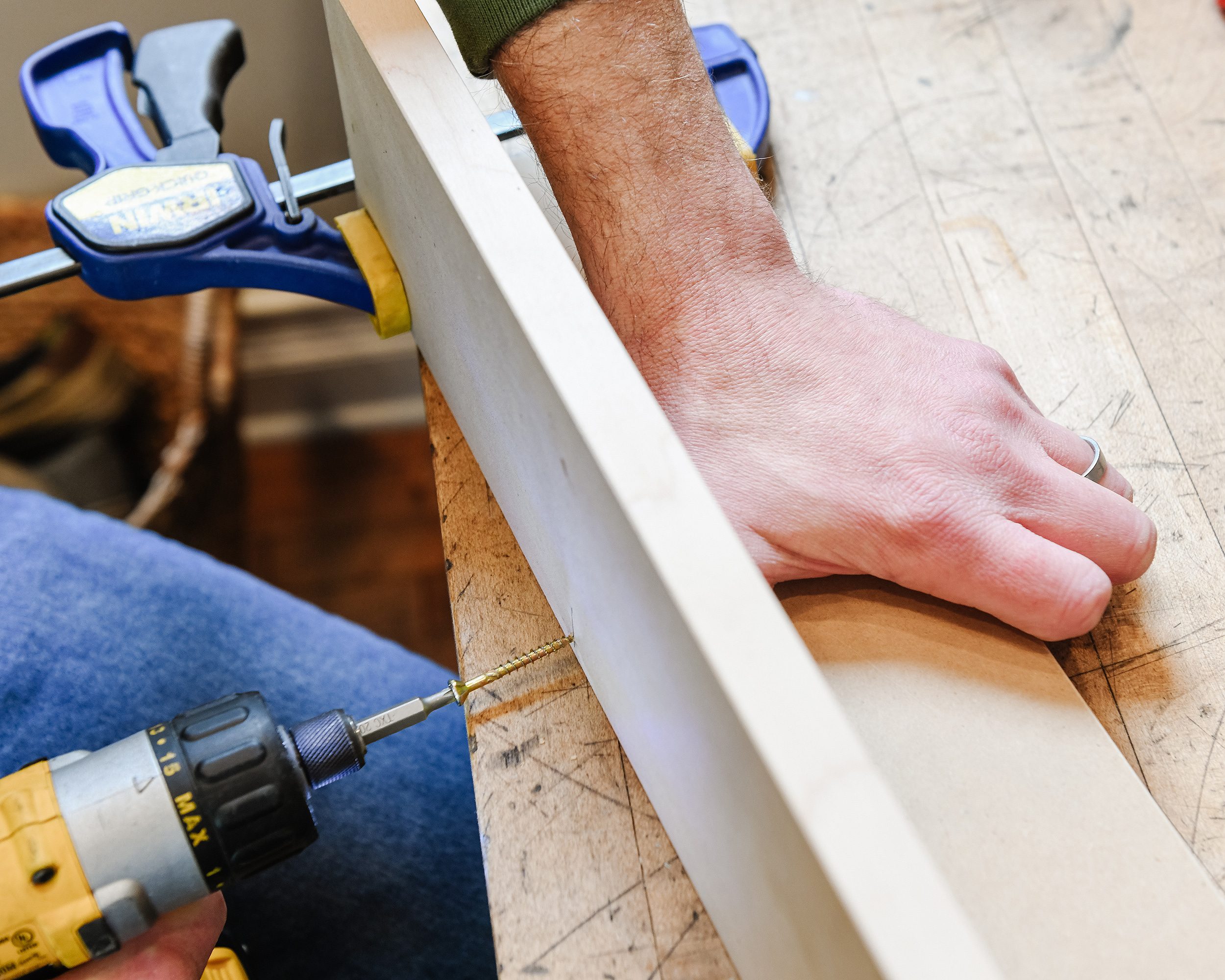 Scott screws together the top and back of the peg rail // via Yellow Brick Home