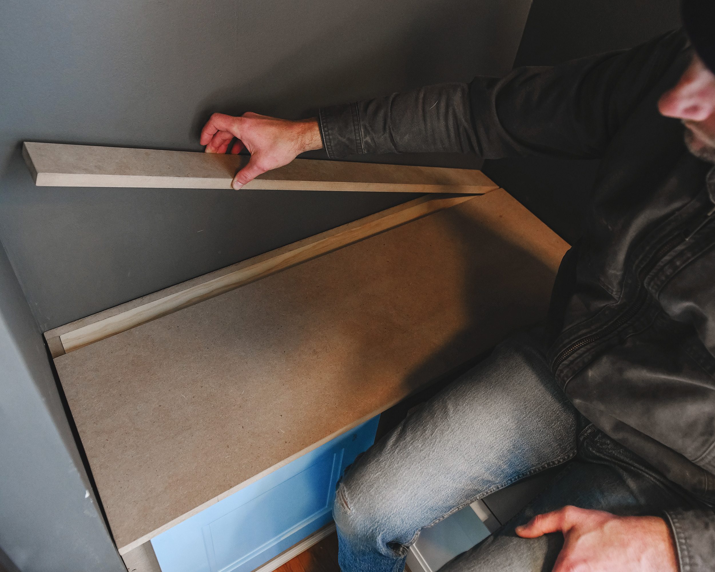 Scott installs the two pieces of the toy box lid // via Yellow Brick Home