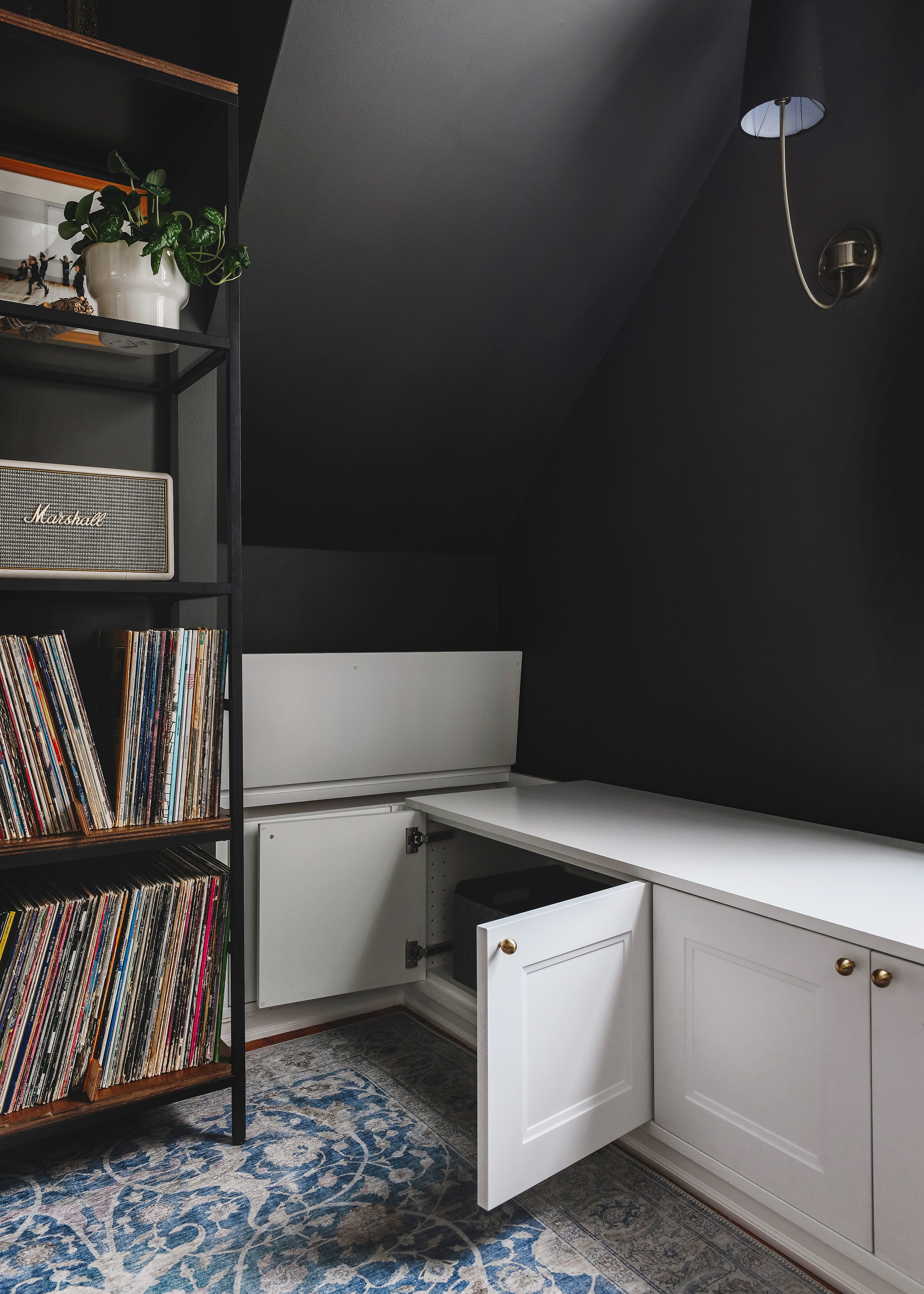 The built in with toy box lid and far left cabinet doors open. There is a TON of storage space // via Yellow Brick Home