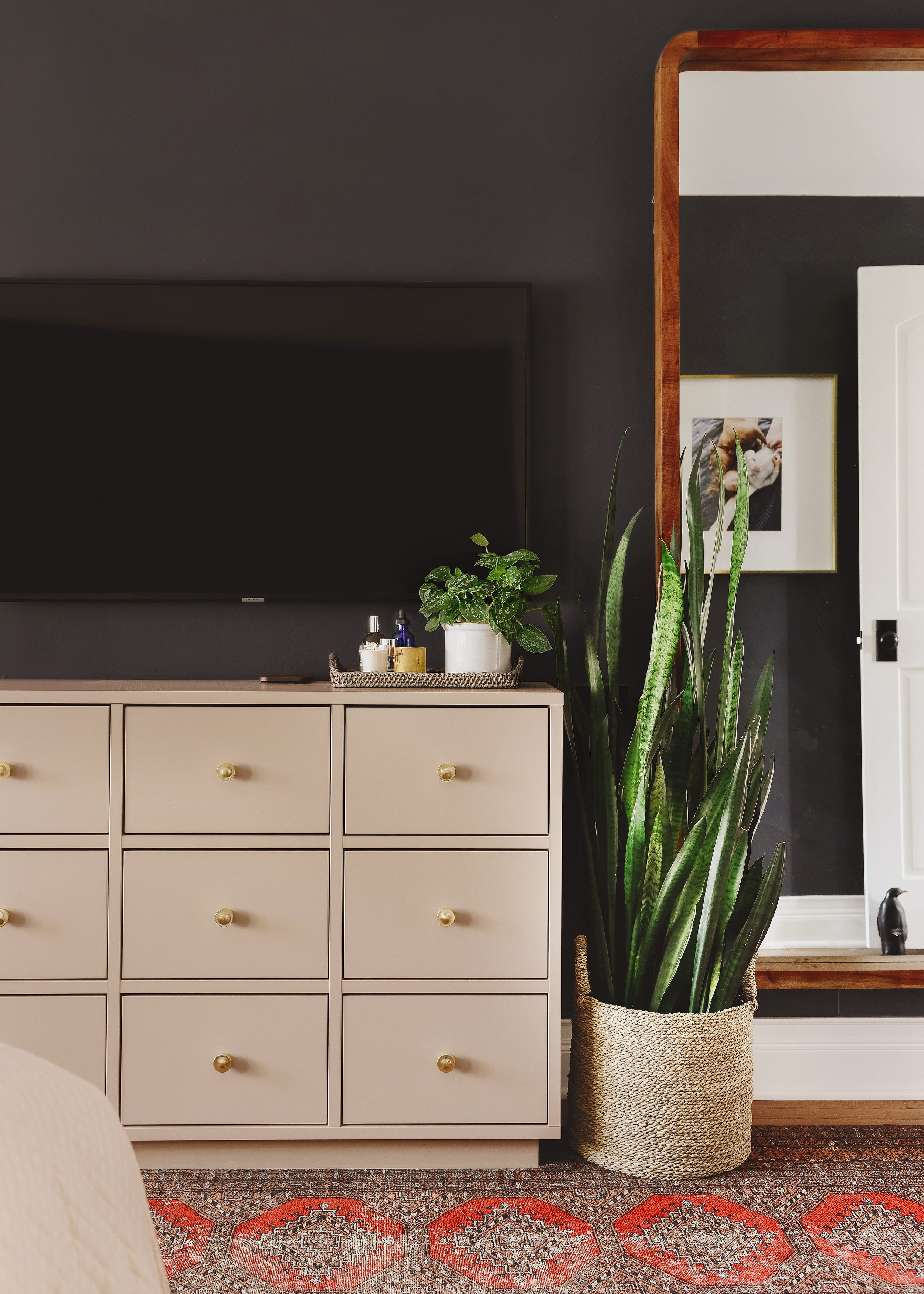 Dark + moody bedroom with a taupe dresser | How We Care for Houseplants via Yellow Brick Home #houseplants