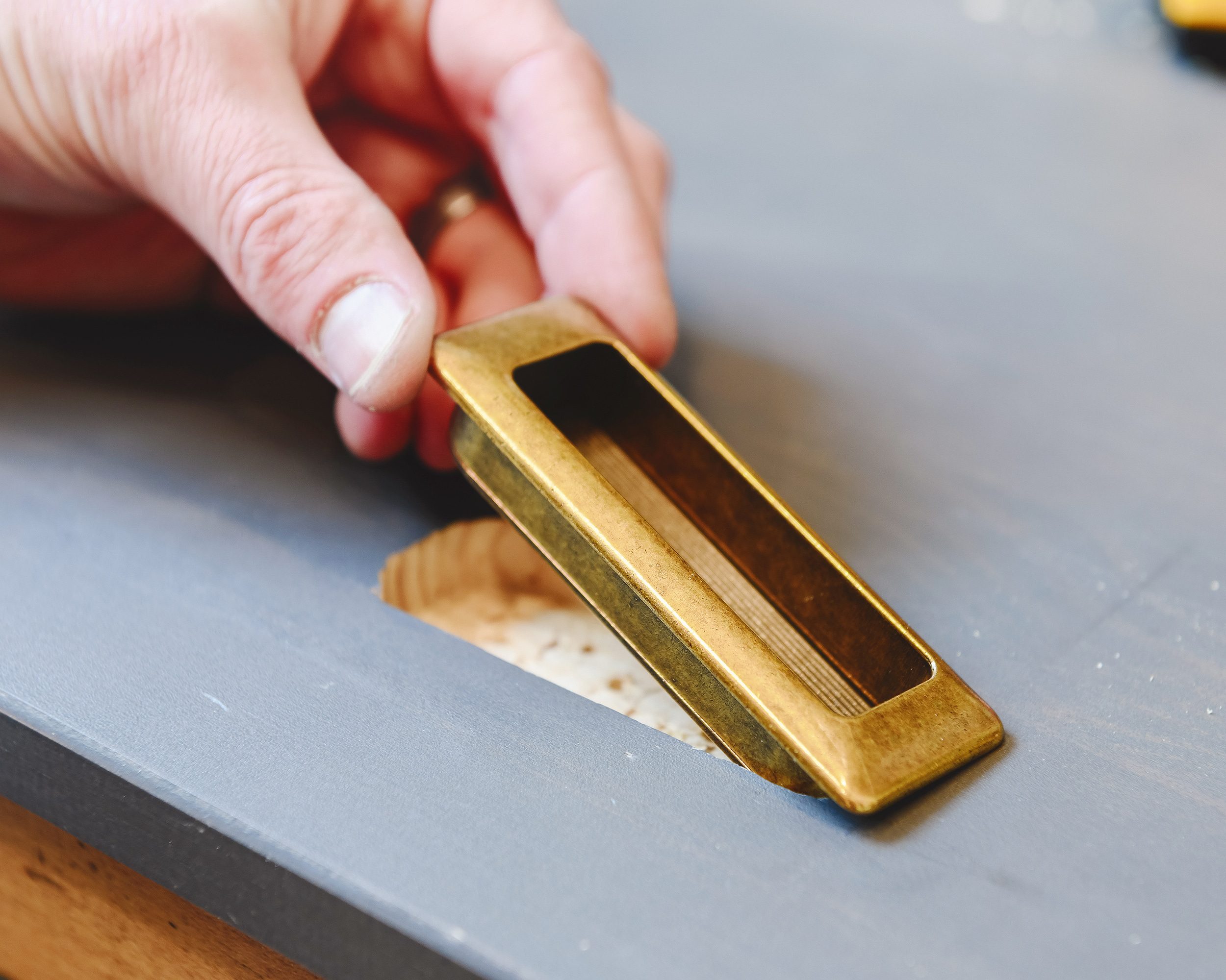 A close-up of installing recessed hardware | via Yellow Brick Home