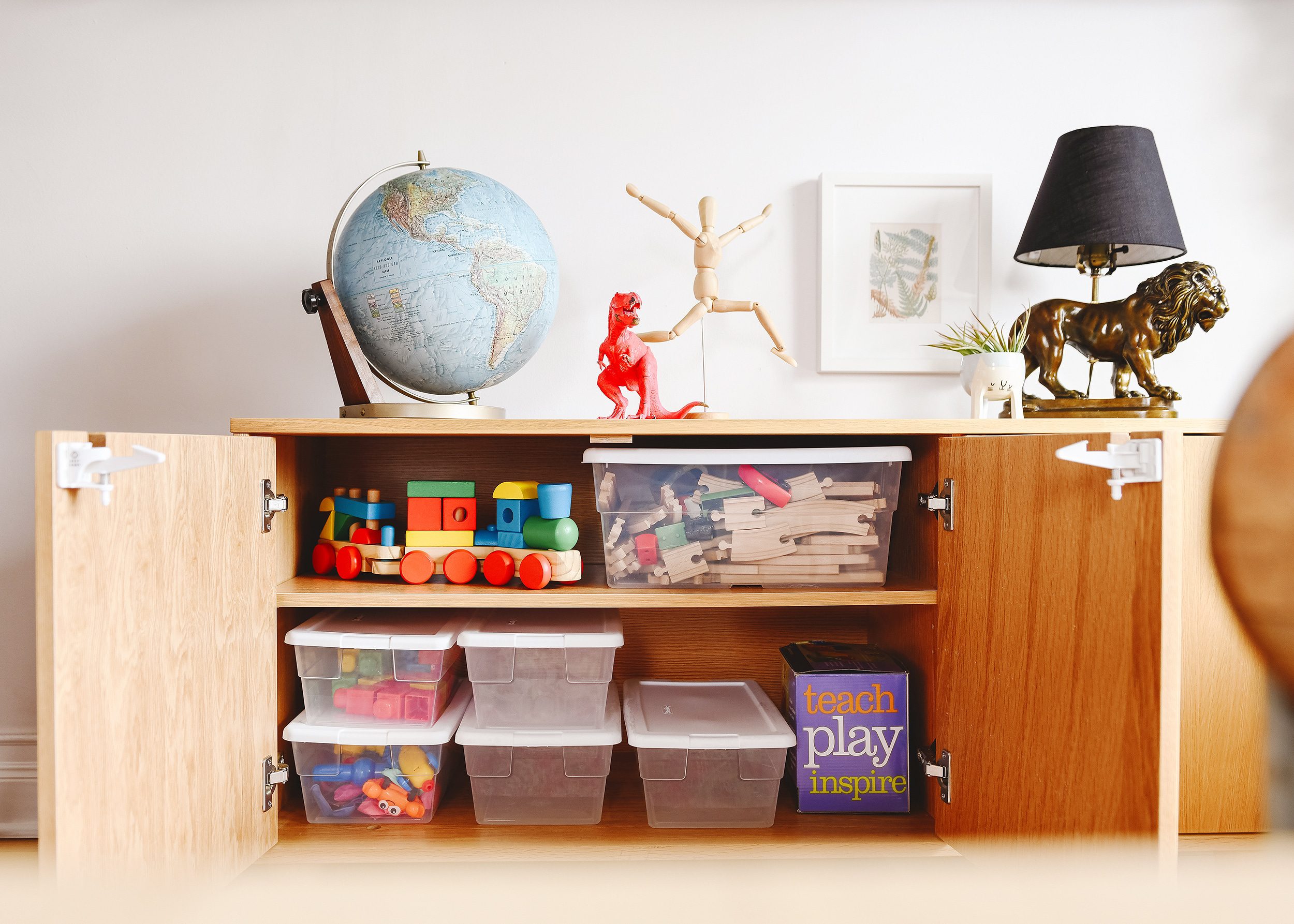 A peek inside our credenza's toy storage | via Yellow Brick Home, a family room and play room reveal!