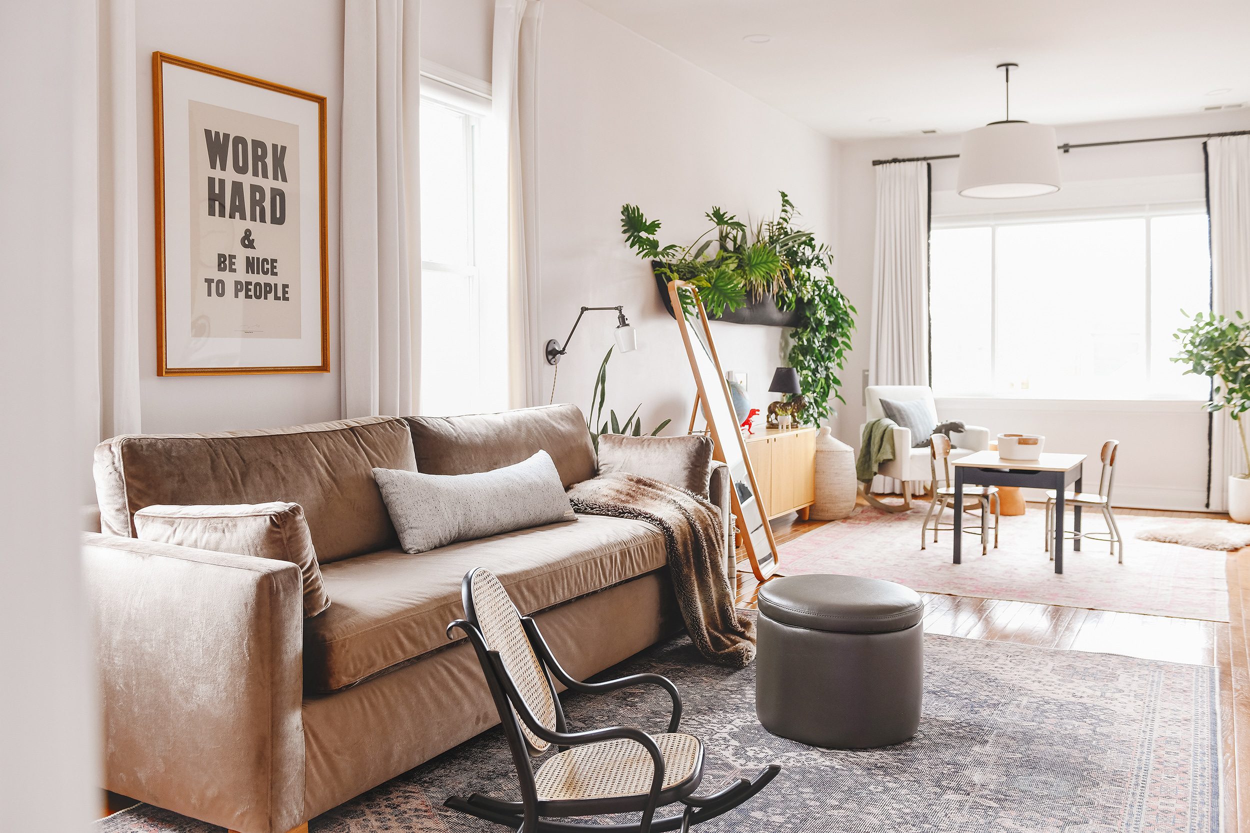 A view into our family room with an art print that says 'Work Hard & Be Nice to People' | via Yellow Brick Home