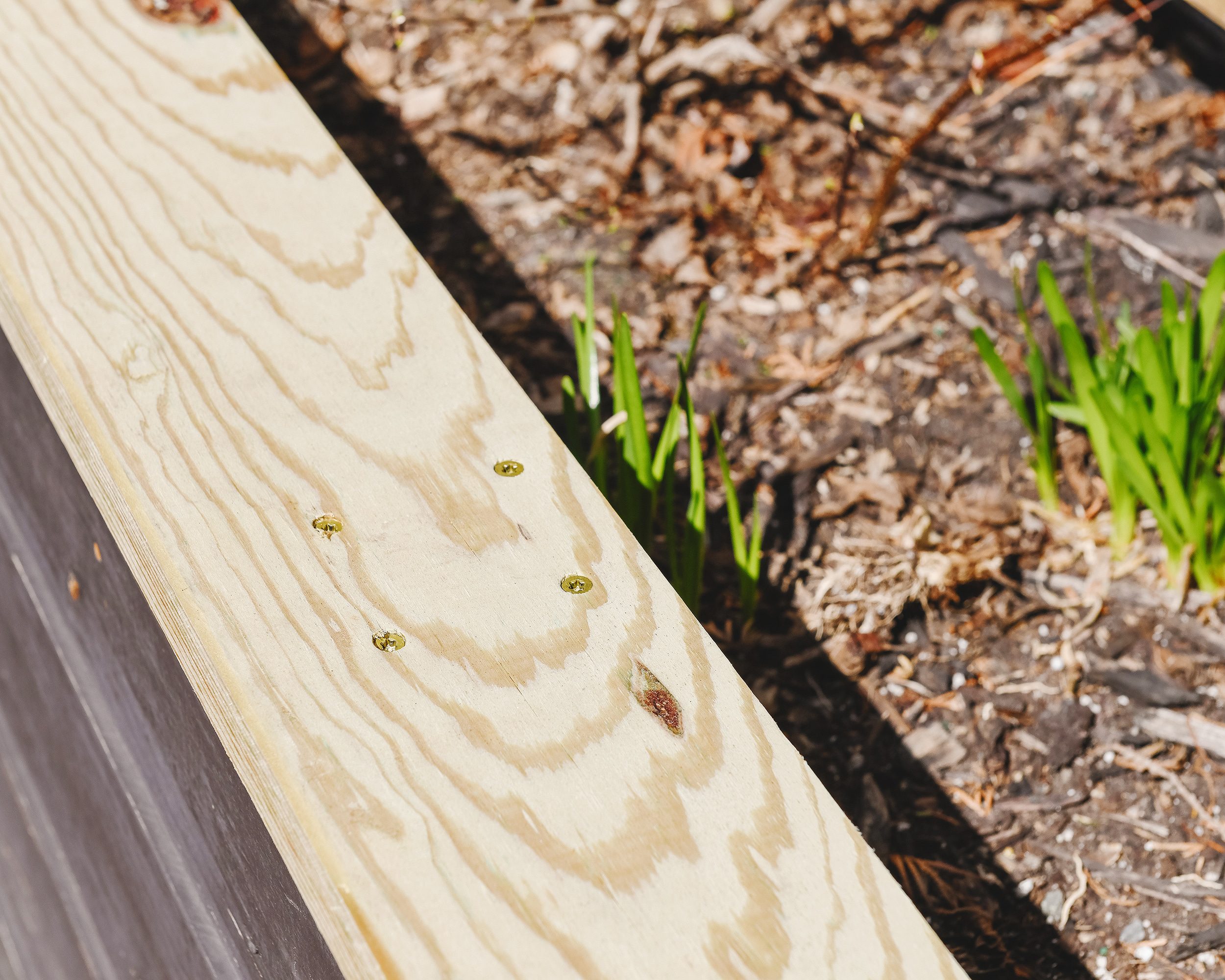 A closeup of the newly replaced top caps on the planter box to the left of the fire pit // via Yellow Brick Home