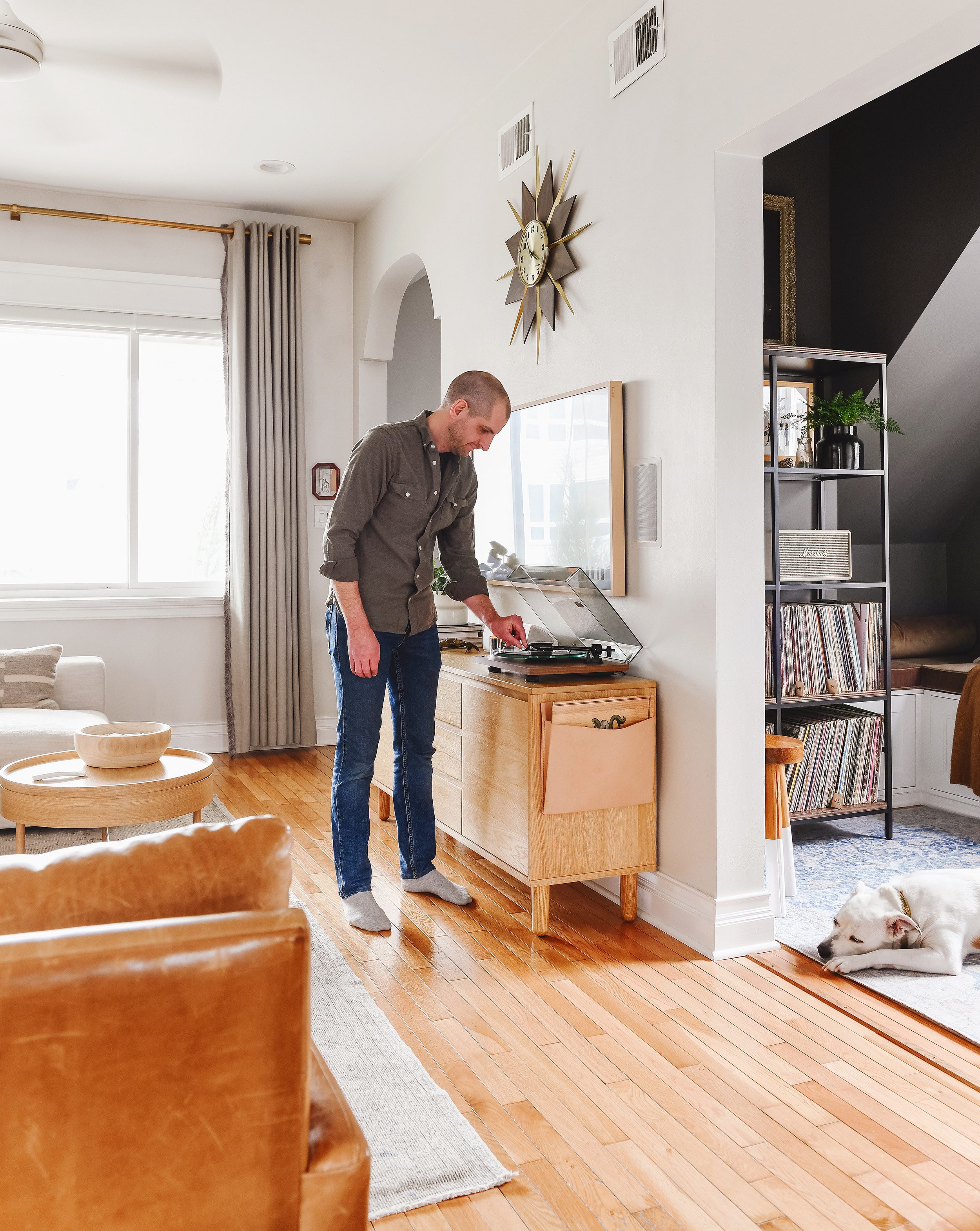 Scott cues up a record on the turntable in the living room of our Chicago home // via Yellow Brick Home