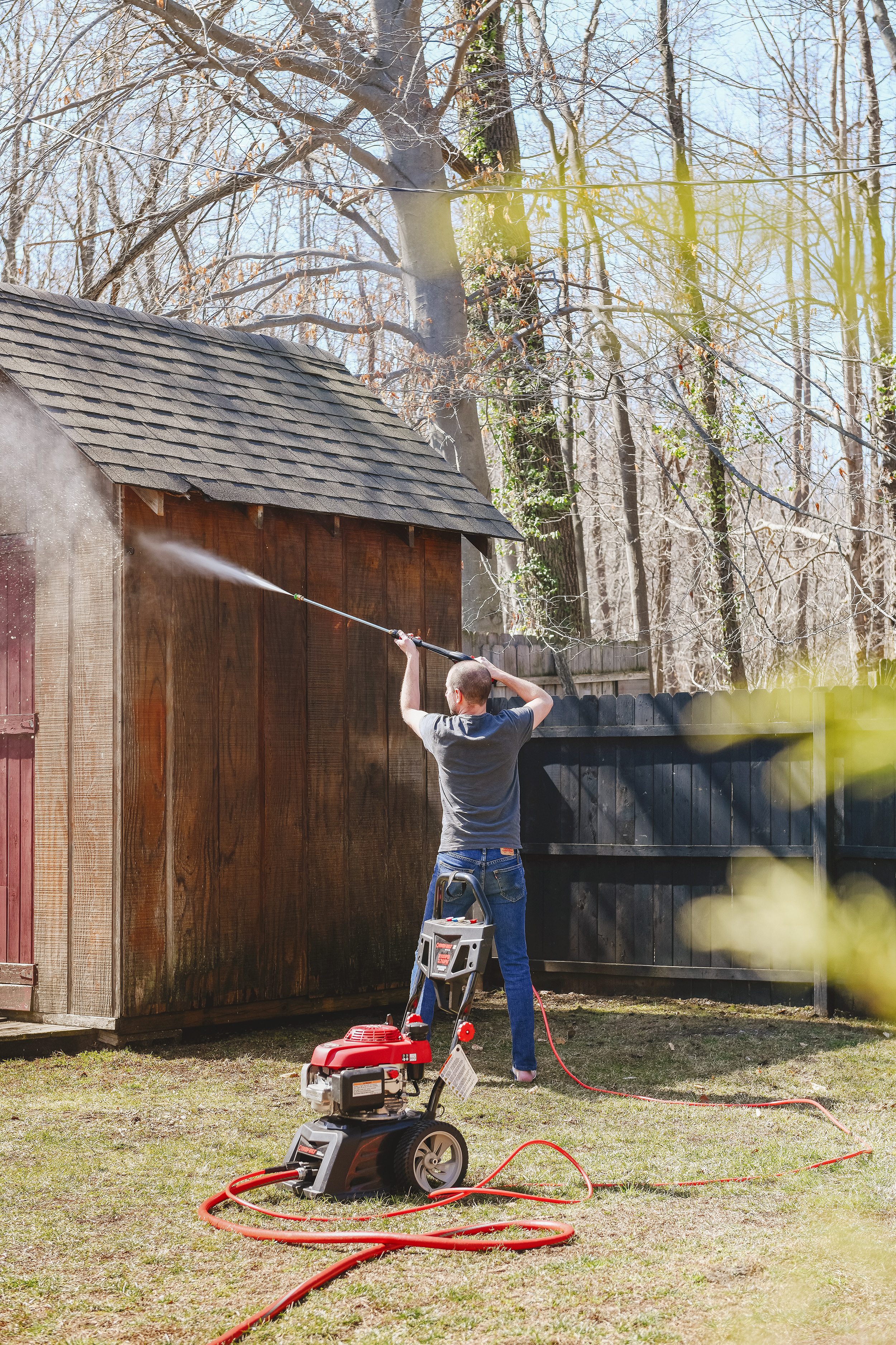 Scott pressure washes the exterior of the shed // via yellow brick home