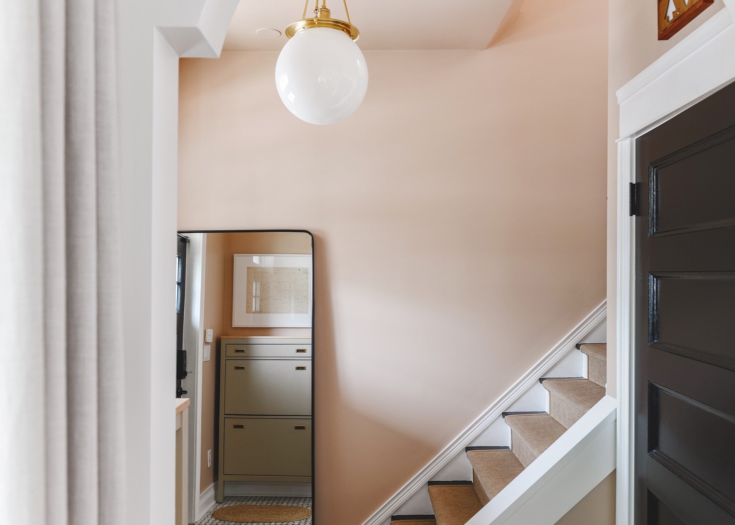 Peachy entryway wide shot | How to Install a Stair Runner in 10 Steps via Yellow Brick Home