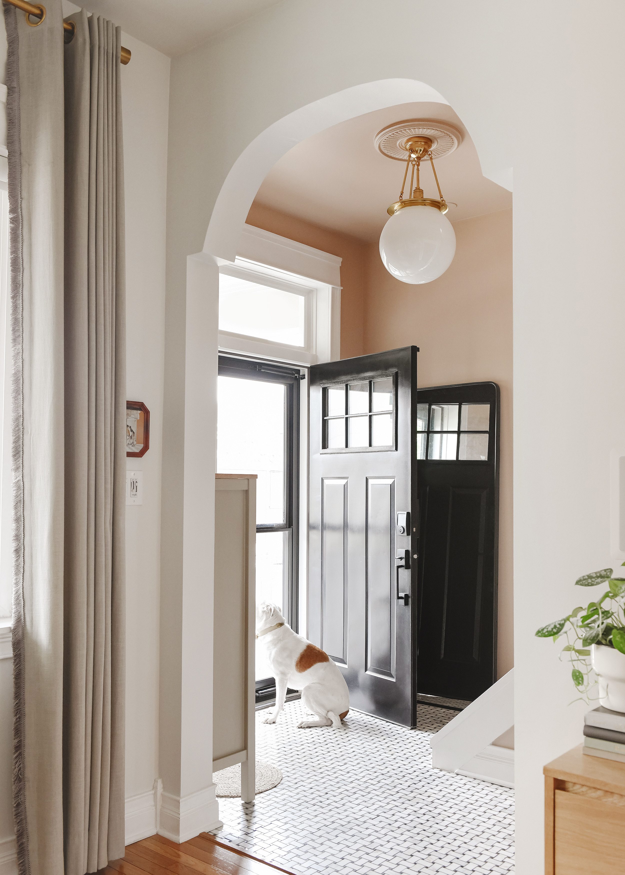 Look at that arch! Entryway is painted Valspar Milk Toast | via Yellow Brick Home