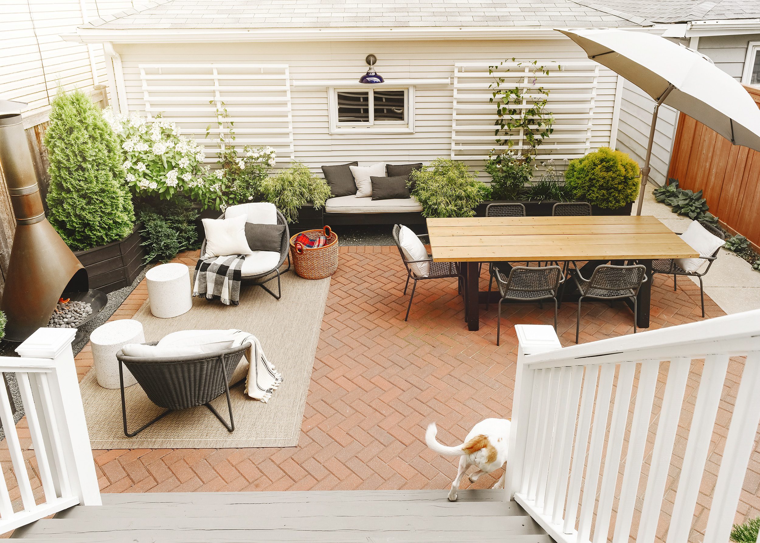 Full view of our backyard while Kitty leaps off the back staircase | via Yellow Brick Home