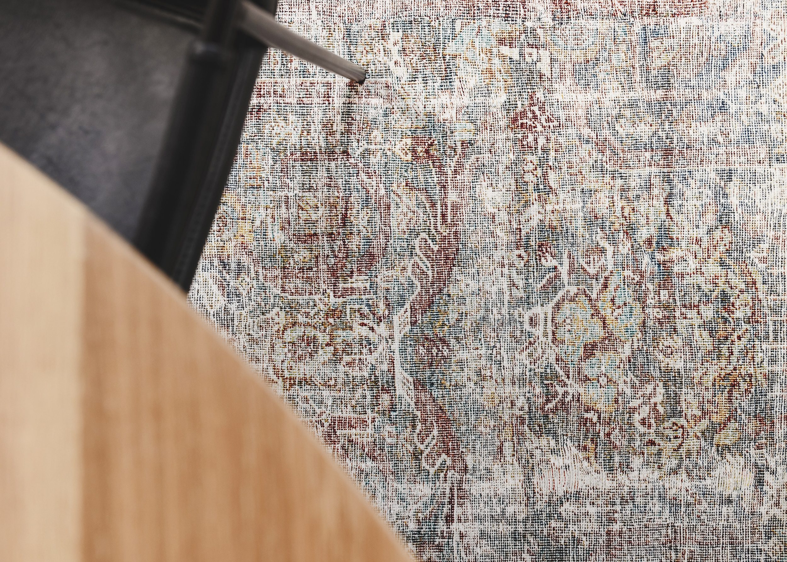 A closeup of the way the tabletop brings out the warmer tones of the rug beneath it. 