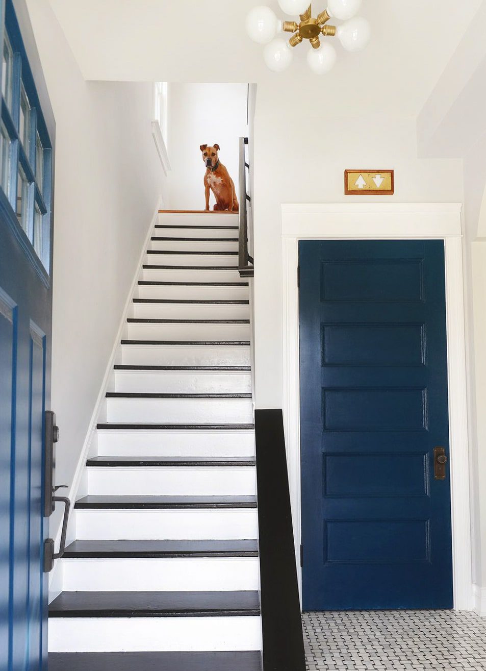 Black and white and navy blue entryway | How to Install a Stair Runner in 10 Steps via Yellow Brick Home