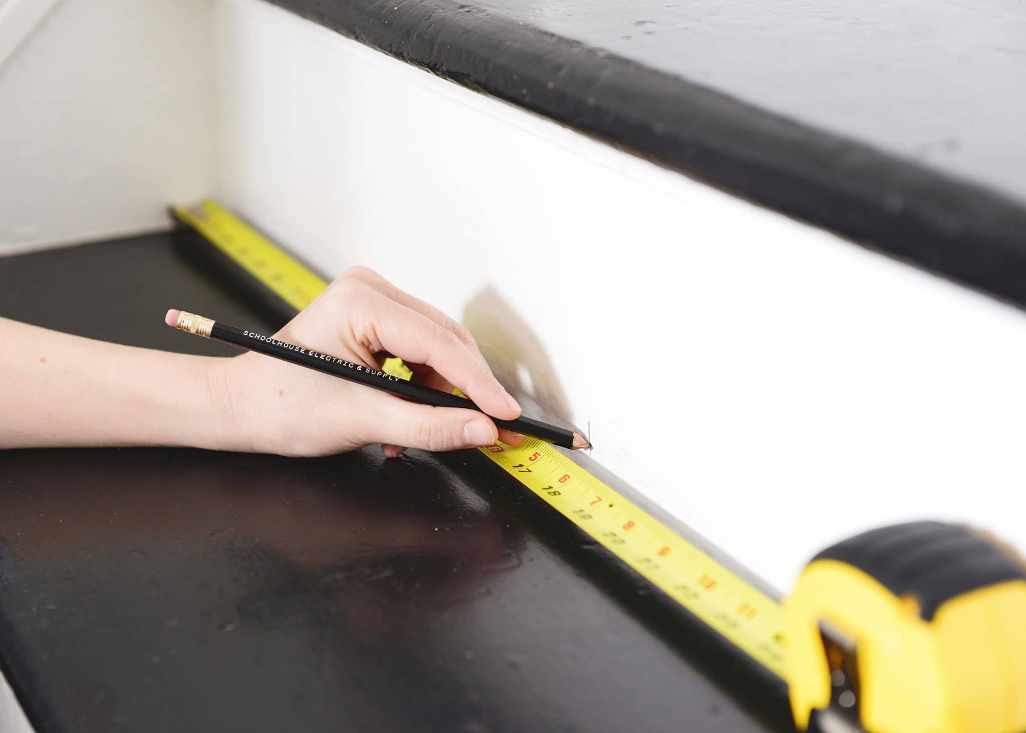 Marking the center of each stair to prepare for runner install | How to Install a Stair Runner in 10 Steps via Yellow Brick Home