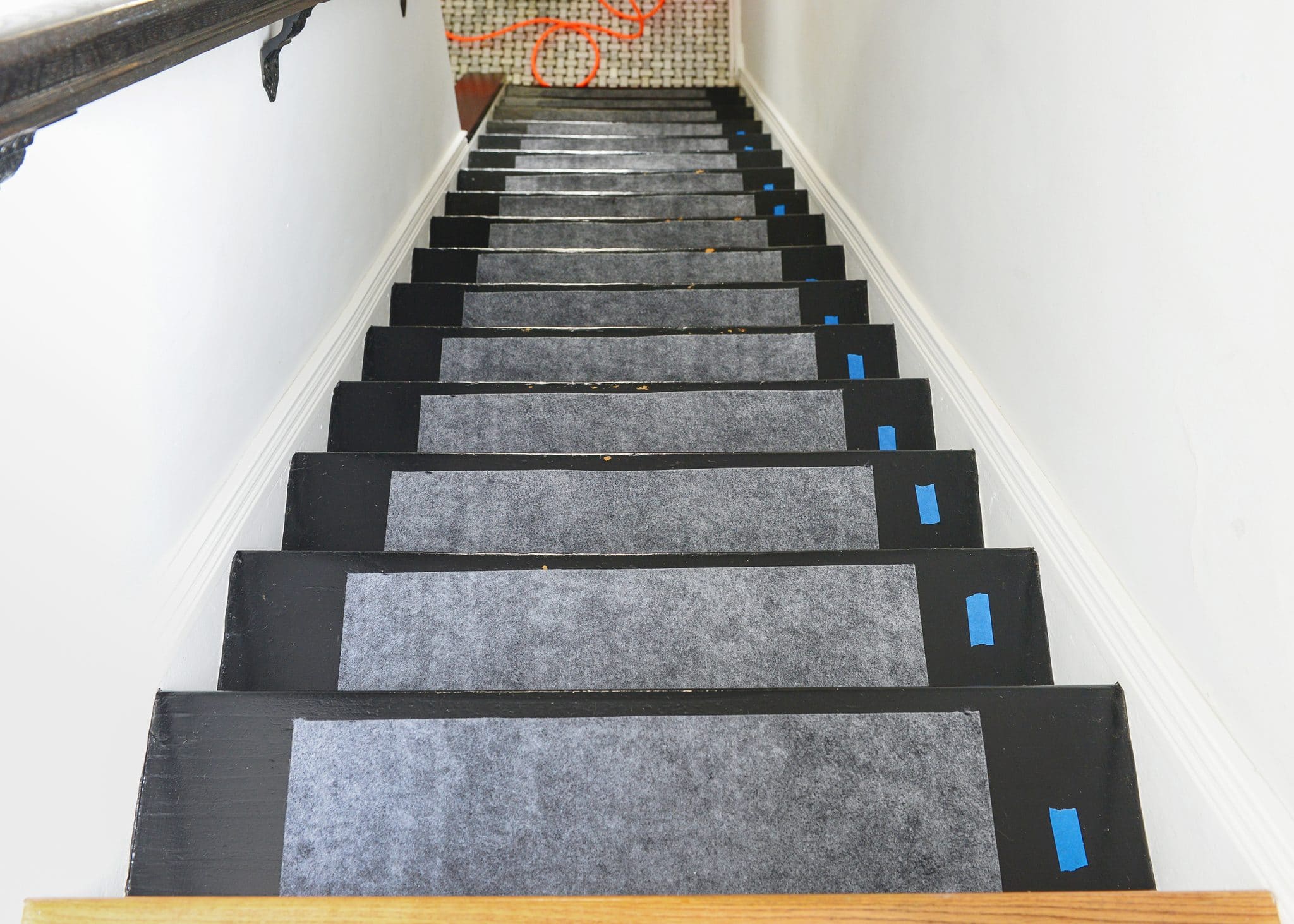Rug pads in place before the installation of a stair runner | How to Install a Stair Runner in 10 Steps via Yellow Brick Home