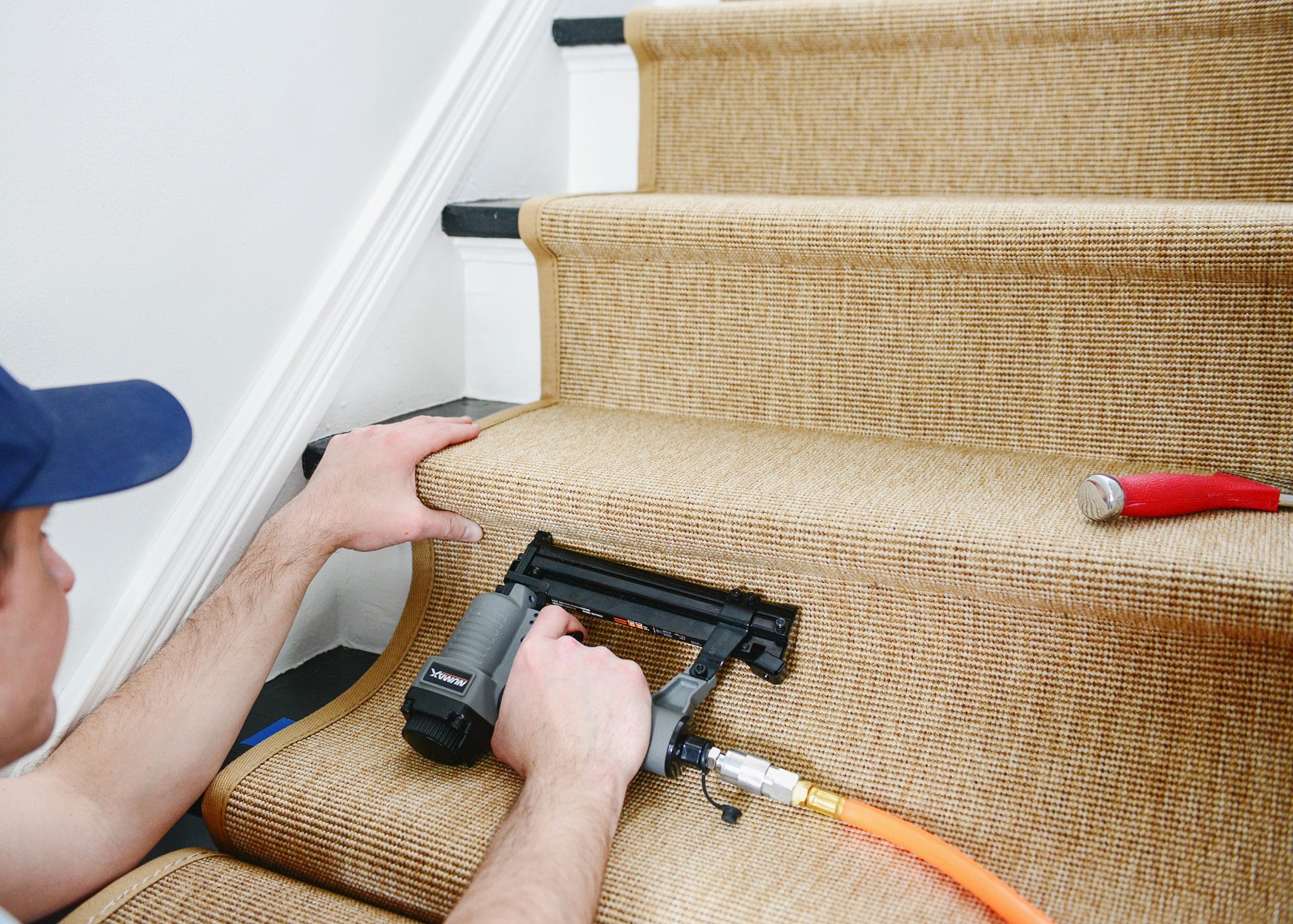 Using the stapler to install a stair runner | How to Install a Stair Runner in 10 Steps via Yellow Brick Home