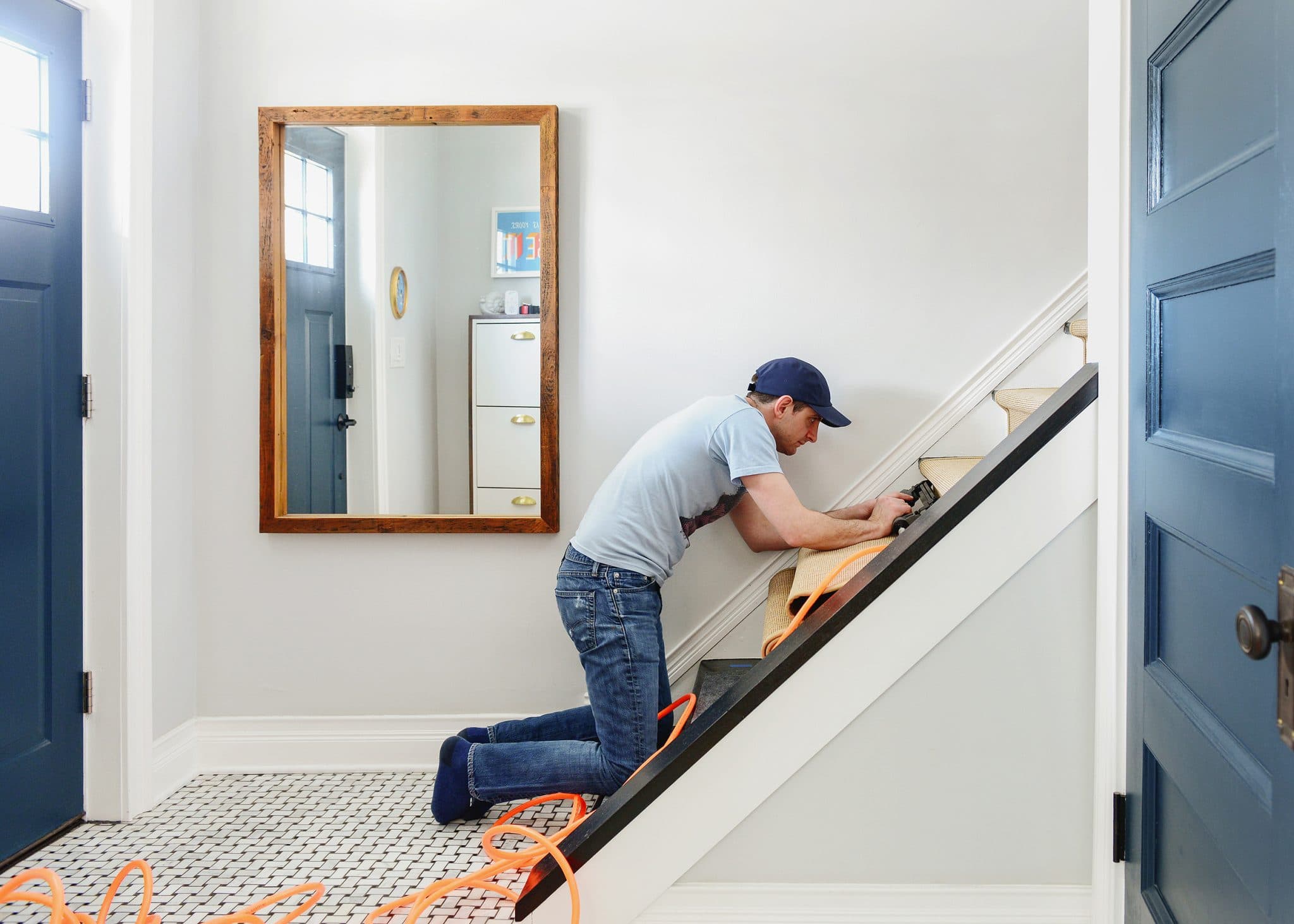 Wide view of the entryway during the installation of stair runner | How to Install a Stair Runner in 10 Steps via Yellow Brick Home