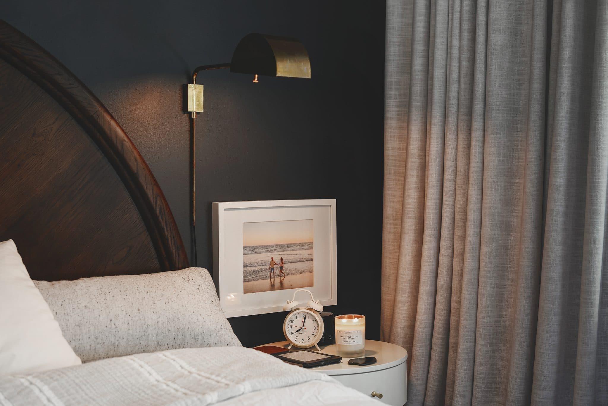 Moody bedroom scene with a candle burning on the night stand | the scents that fill our home, via Yellow Brick Home