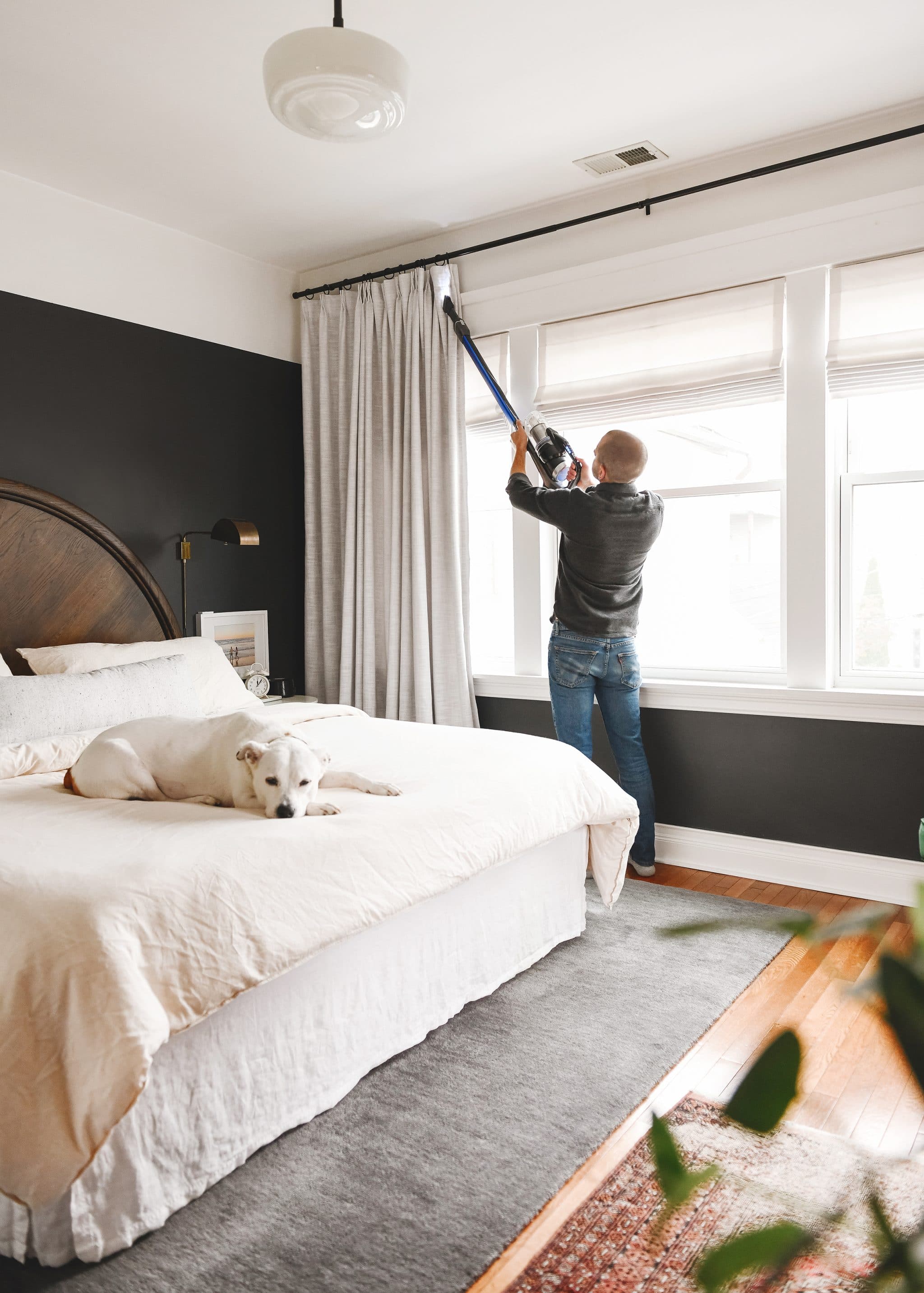 Scott uses the BISSELL® ICONpet® EDGE with the extension tube to clean our bedroom curtains. 