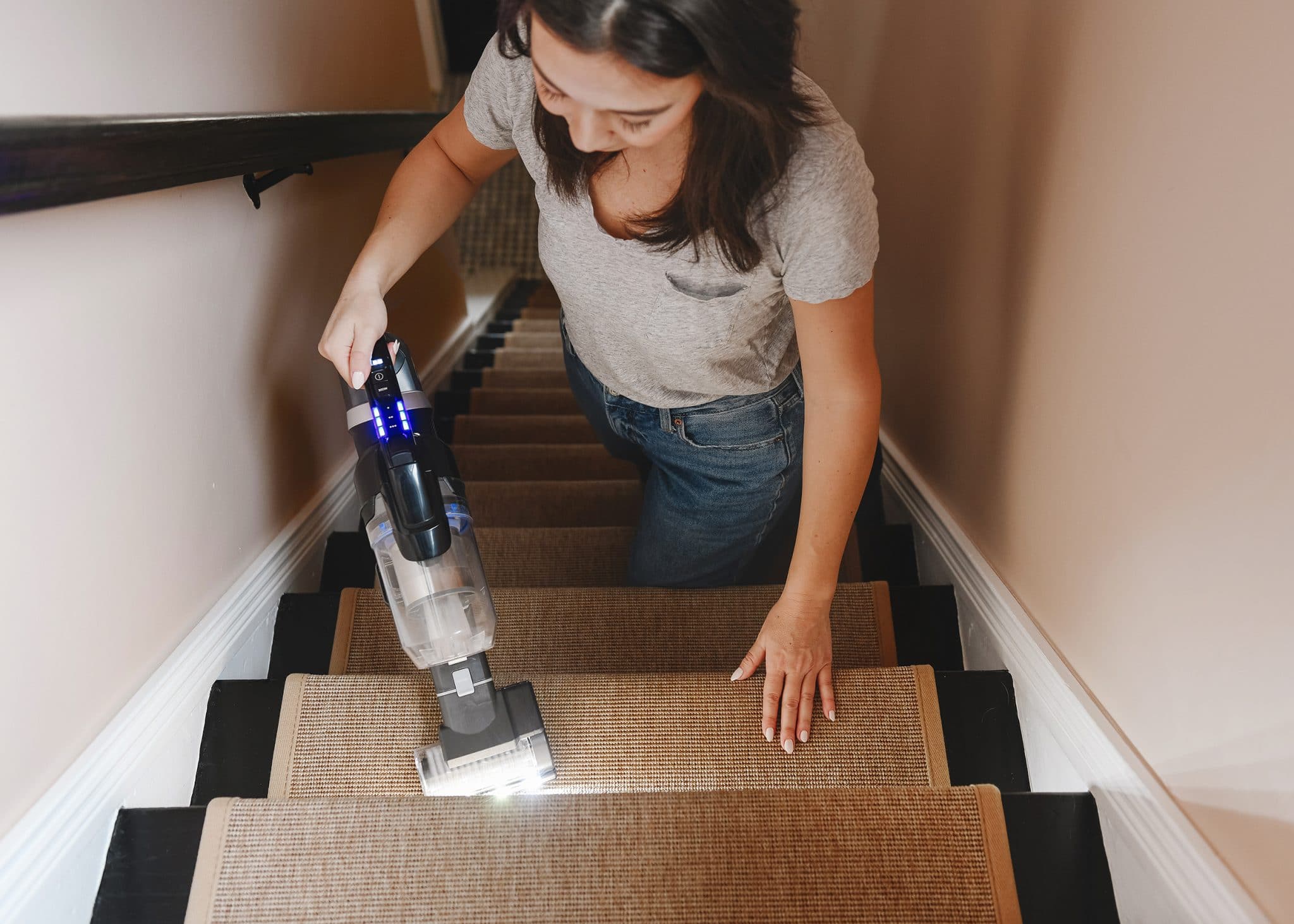 Kim uses the BISSELL® ICONpet® EDGE to vacuum our stair runner. 