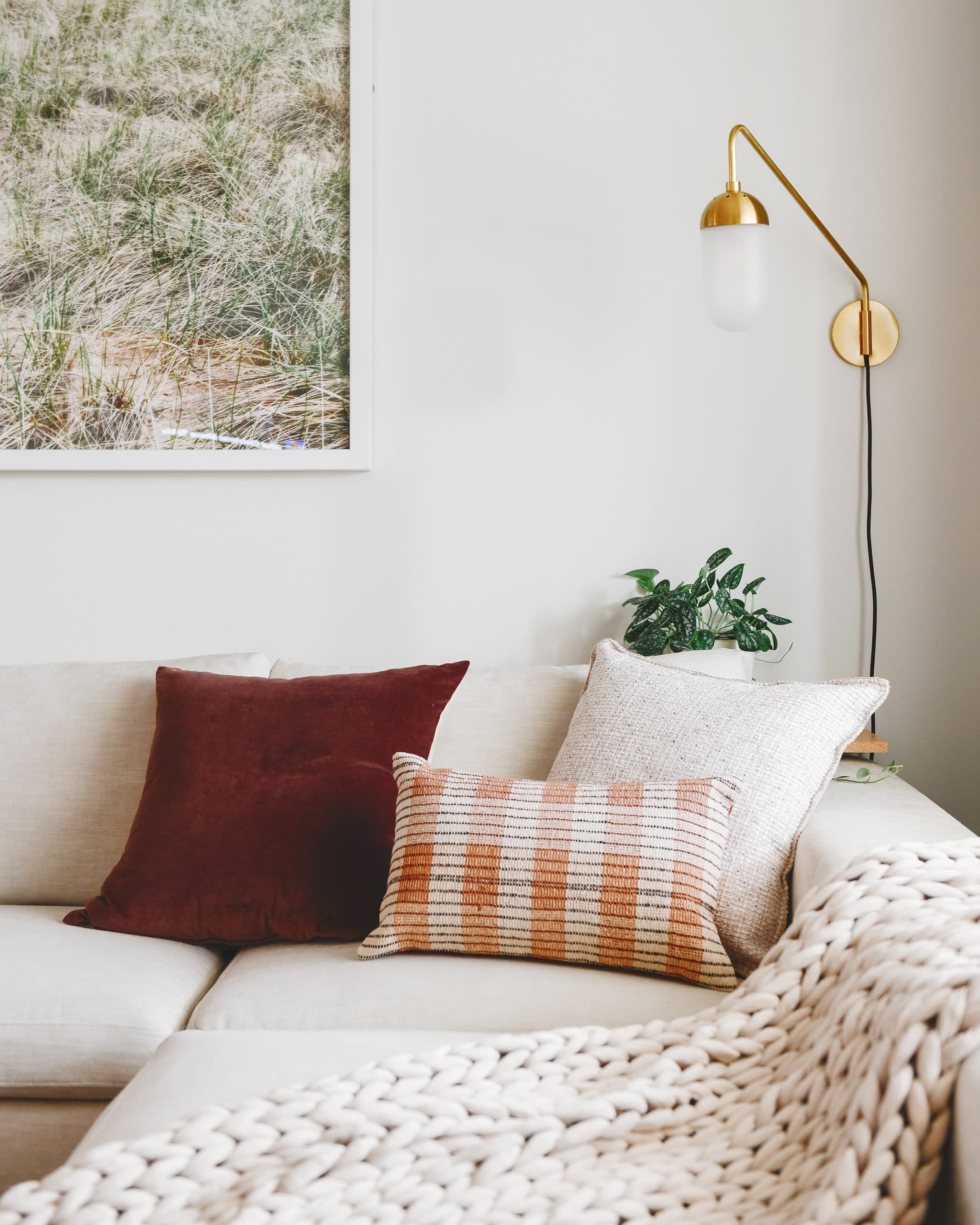 Close up of corner pillows on sectional | I'm sharing my simple, inviting formula for styling pillows on an L-shaped or U-shaped sofa, via Yellow Brick Home