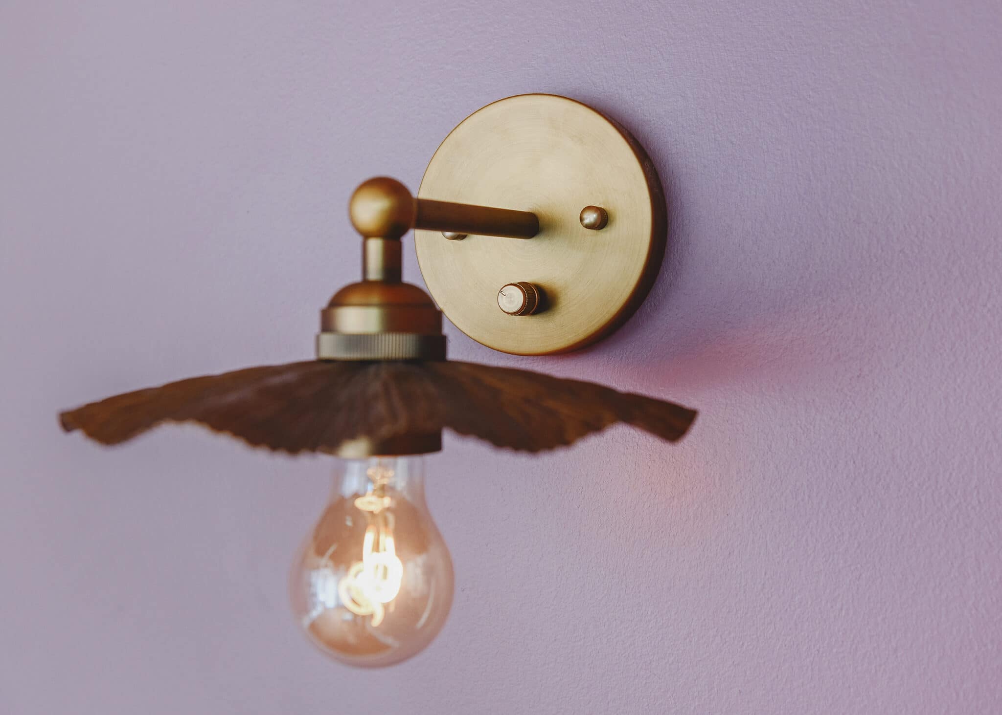 Brass sconce close-up with a newly installed rotary dimmer | via Yellow Brick Home