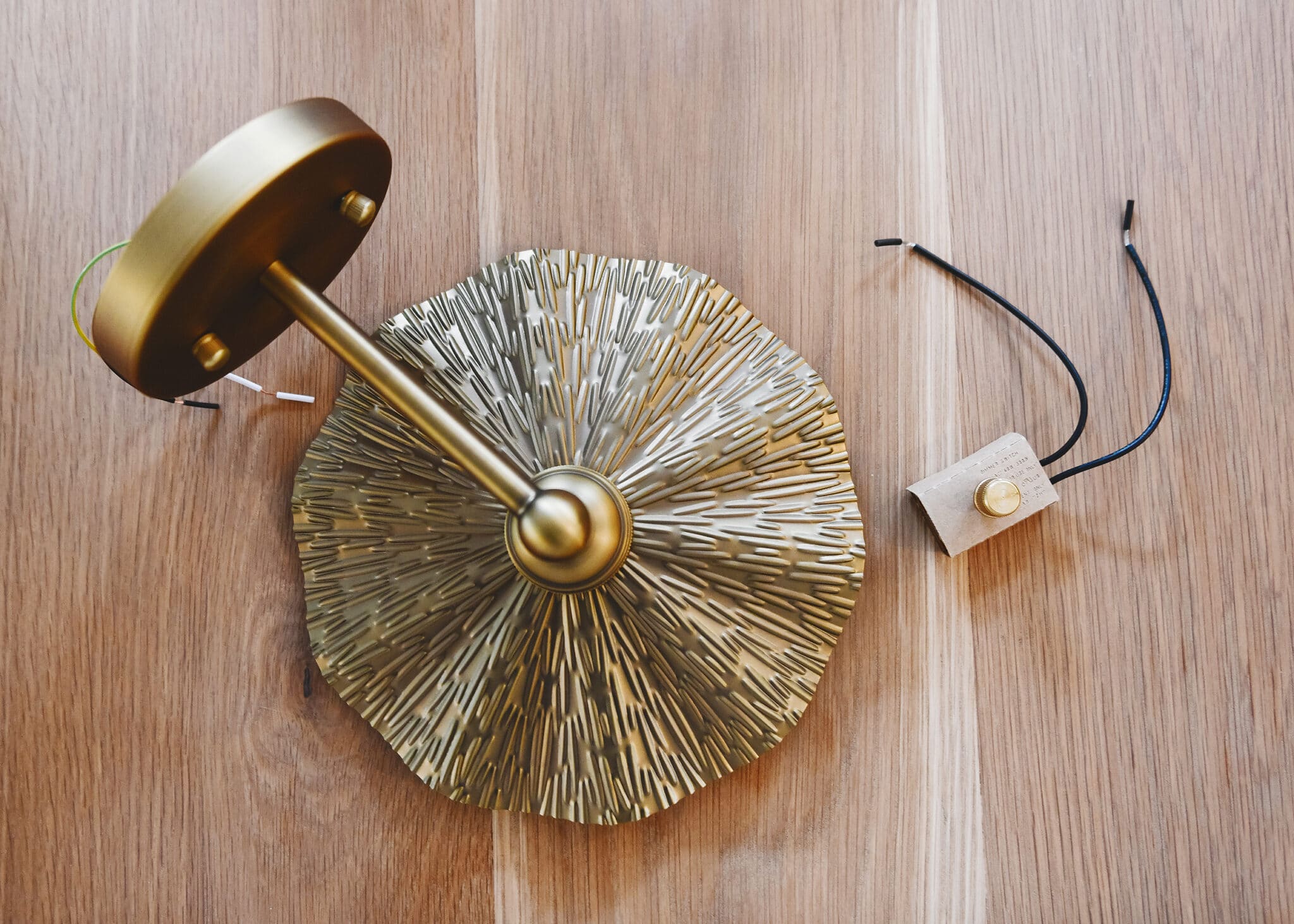 Brass sconce and rotary dimmer ready for installation | via Yellow Brick Home