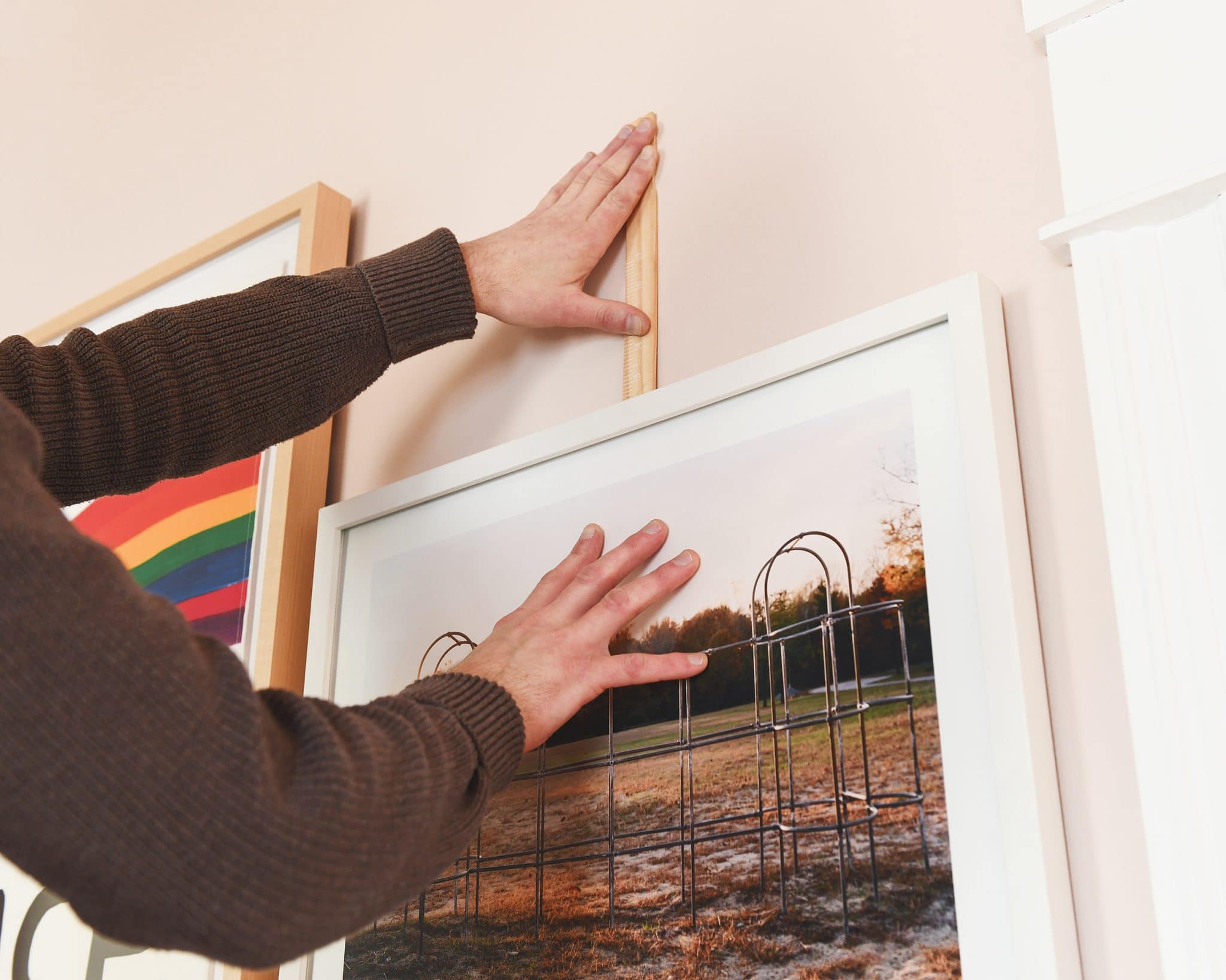 How a paint stick helps us to hang photos | photo hanging trick | How we hide our television with a gallery wall! |  via Yellow Brick Home
