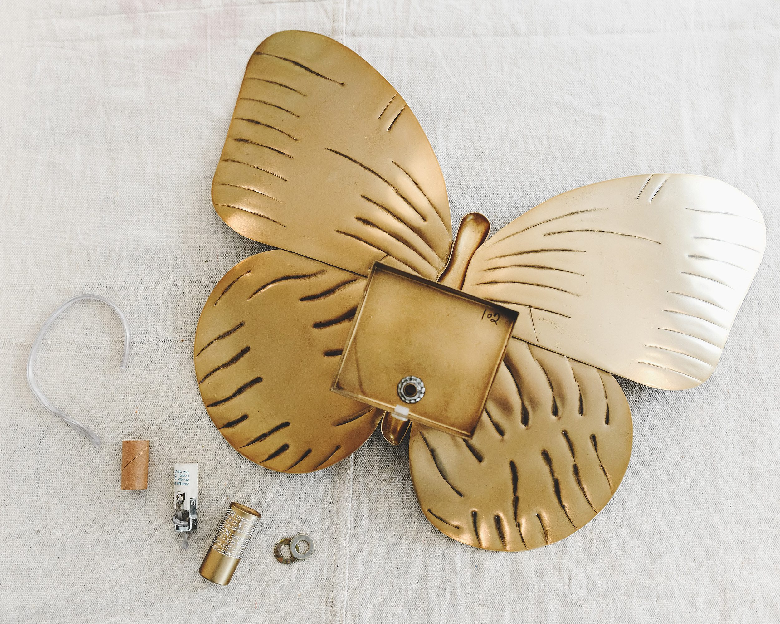 Disassembling the sconce in preparation for rewiring // via Yellow Brick Home