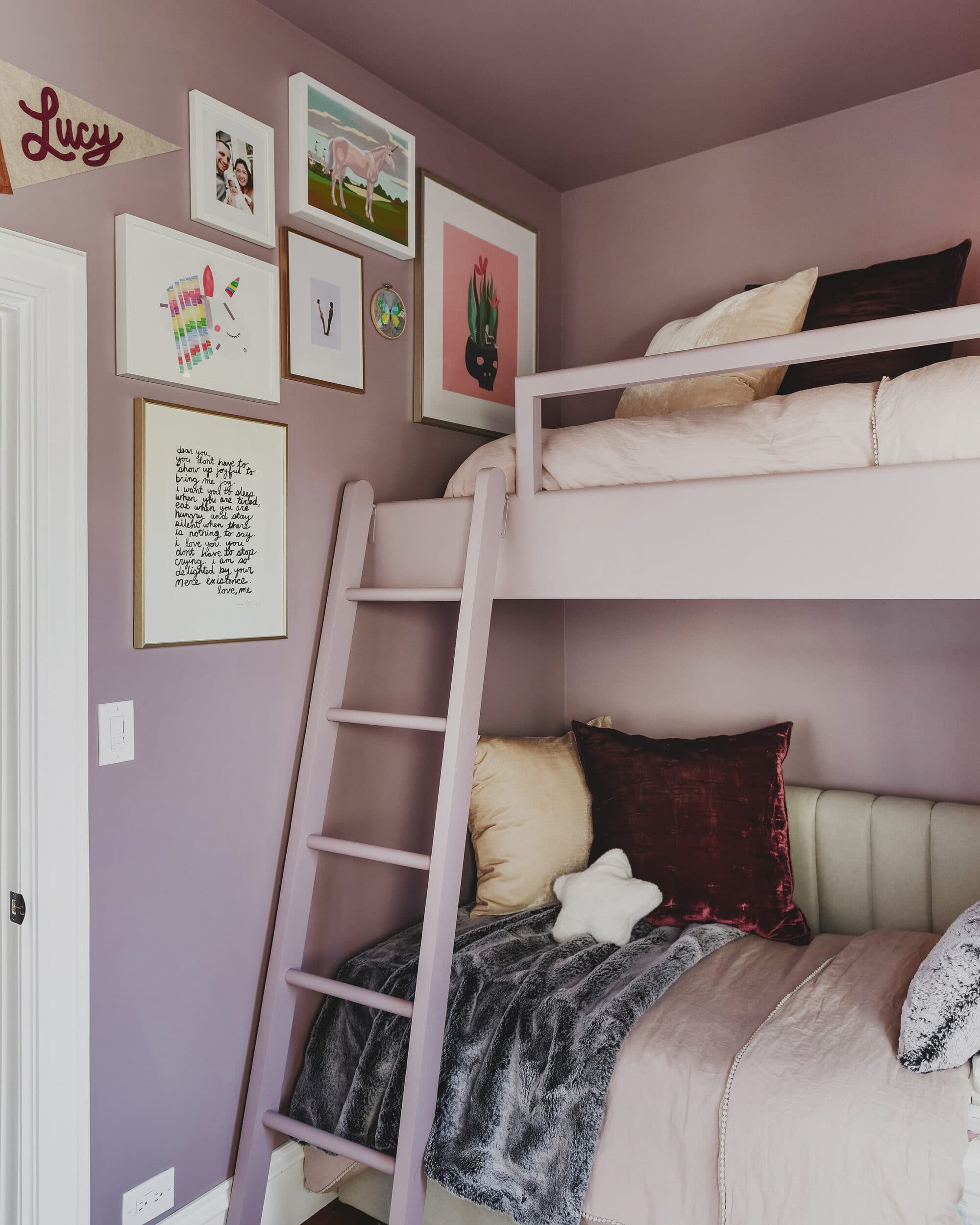 Closer look at bunk bed with gallery wall intertwined | purple and unicorn bedroom for a big kid via Yellow Brick Home