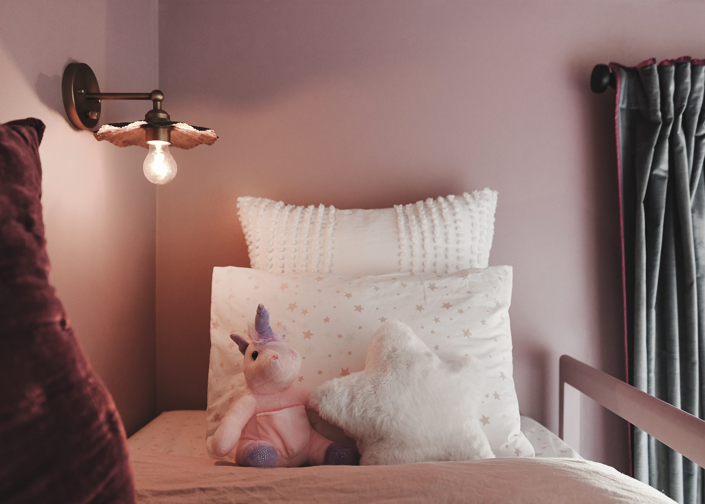 Detail of floral sconce and top bun k with purple walls | purple and unicorn bedroom for a big kid via Yellow Brick Home