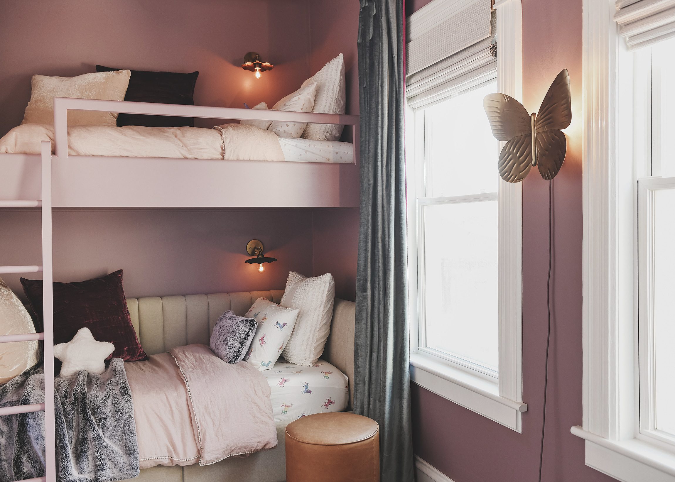 Butterfly sconce and bunk beds with purple walls in big kid bedroom | purple and unicorn bedroom for a big kid via Yellow Brick Home