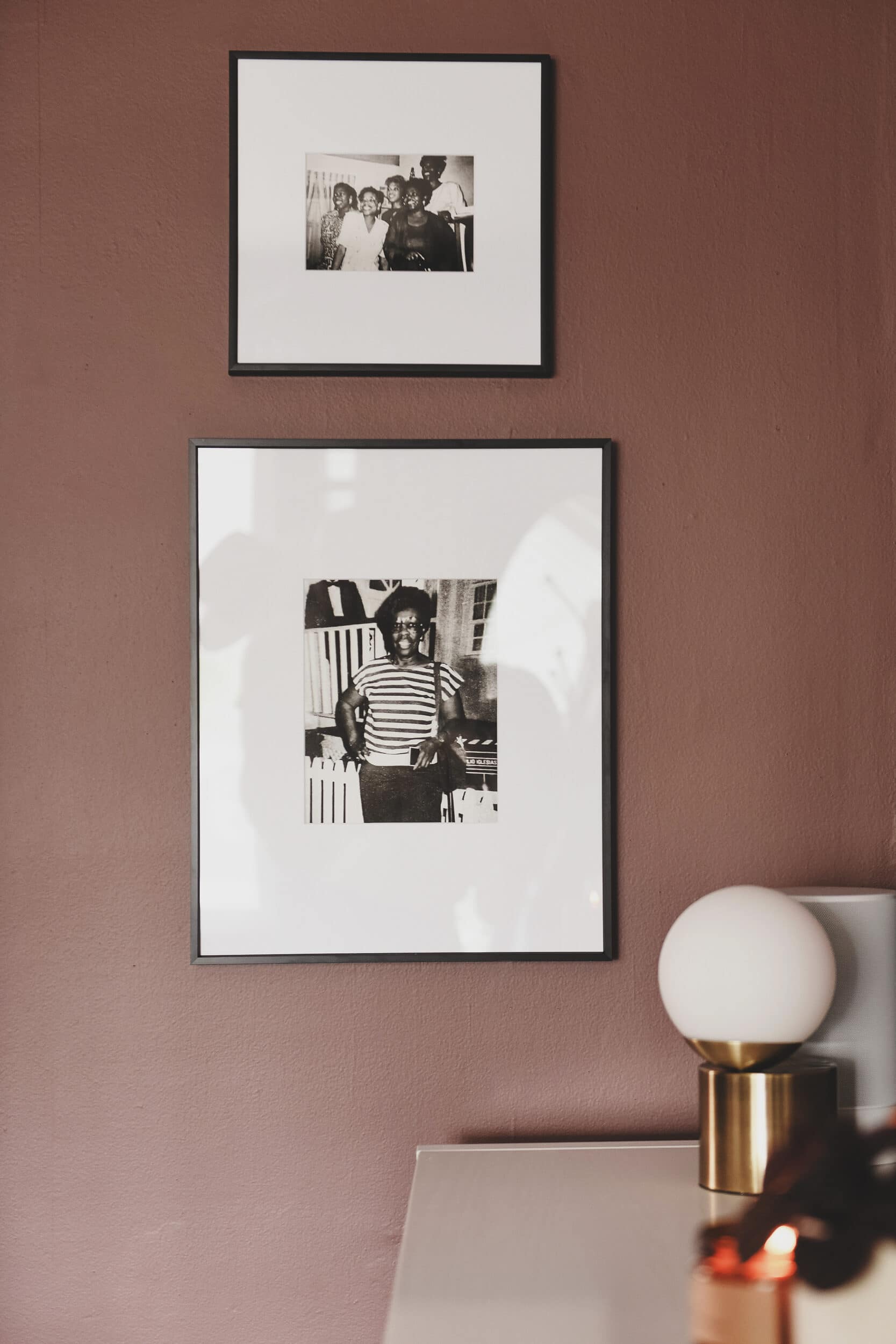 Framed photos of LaTanya's family flank the television and anchor the wall between the two rooms. // via yellow brick home. 