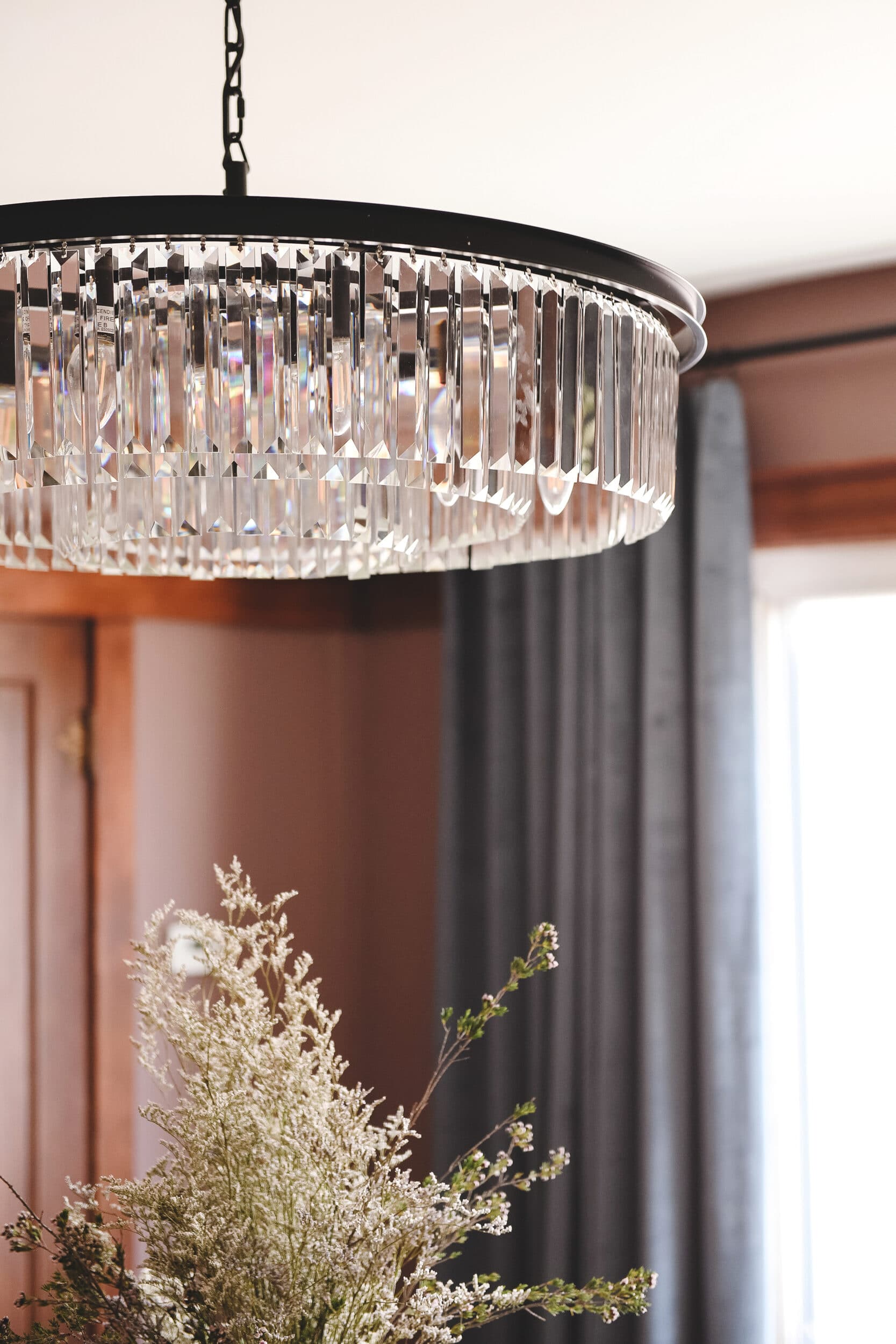 The new black metal and glass chandelier casts a beautiful glow in the evening // via yellow brick home.