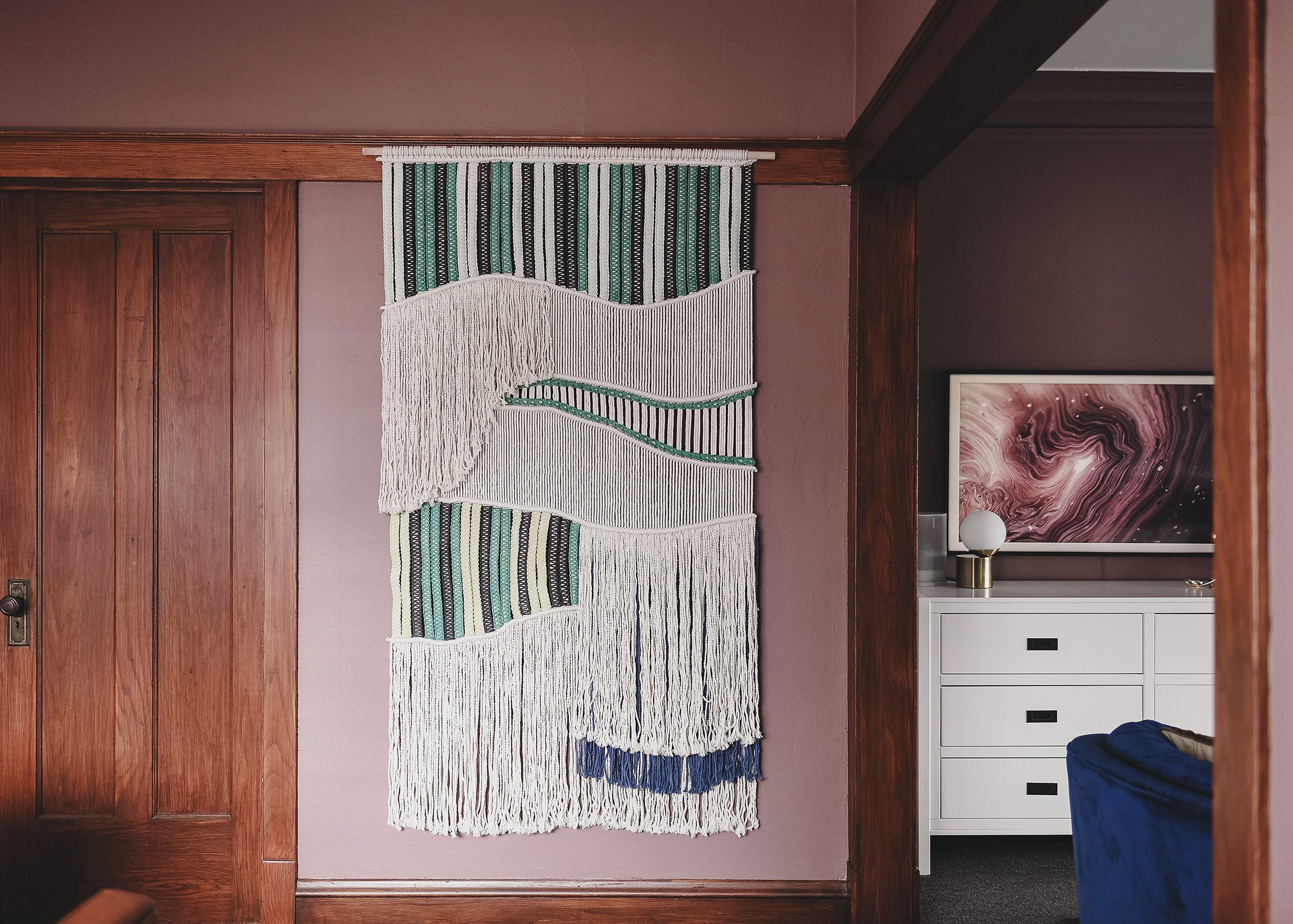 A fiber art piece ties the colors in each room together and unifies the spaces // via yellow brick home.