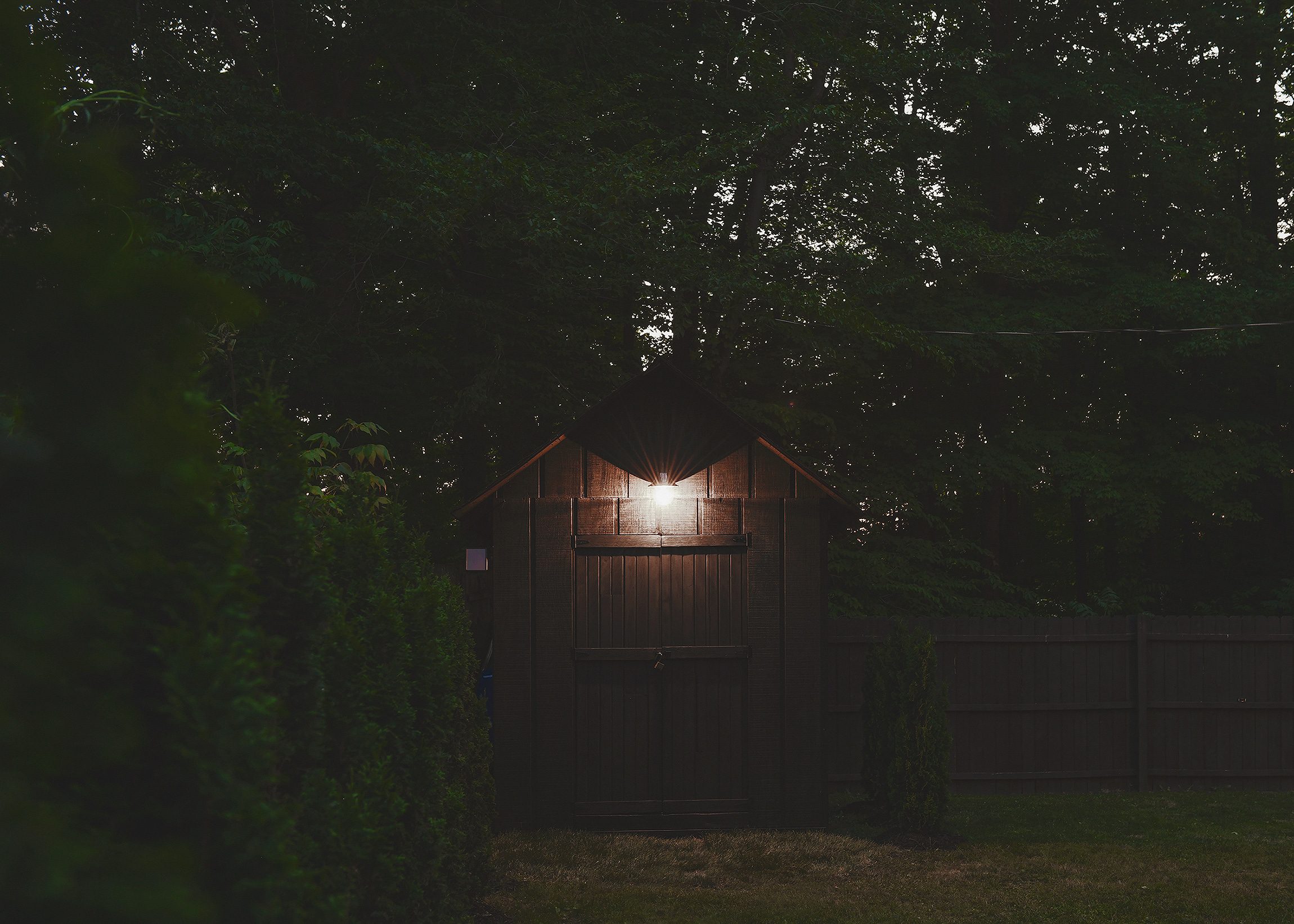 Our shed in the evening, giving off a warm glow from the solar light fixture | via Yellow Brick Home
