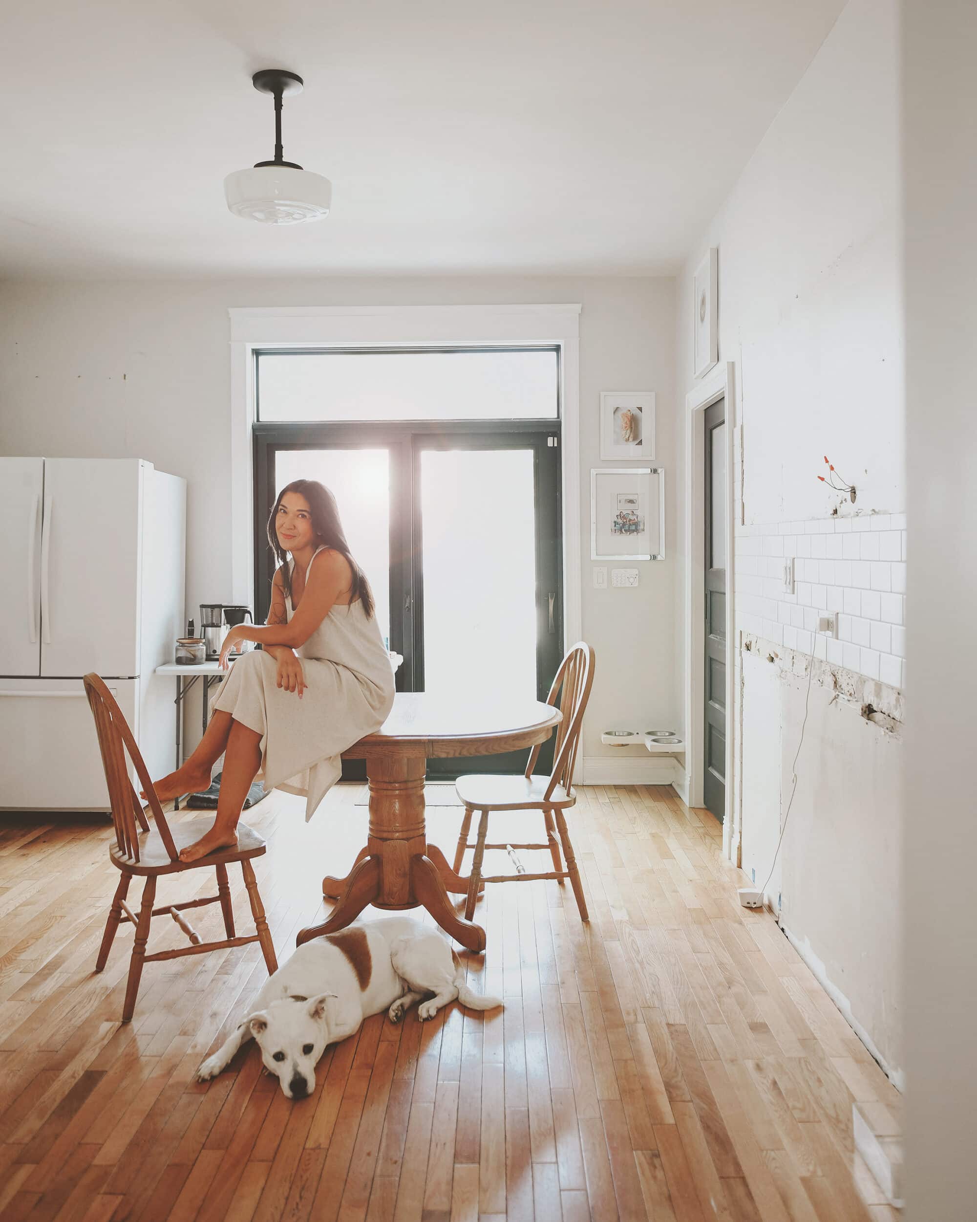How we sold our entire kitchen and made it a win for everyone | Kim and Kitty sitting in an empty kitchen | via Yellow Brick Home
