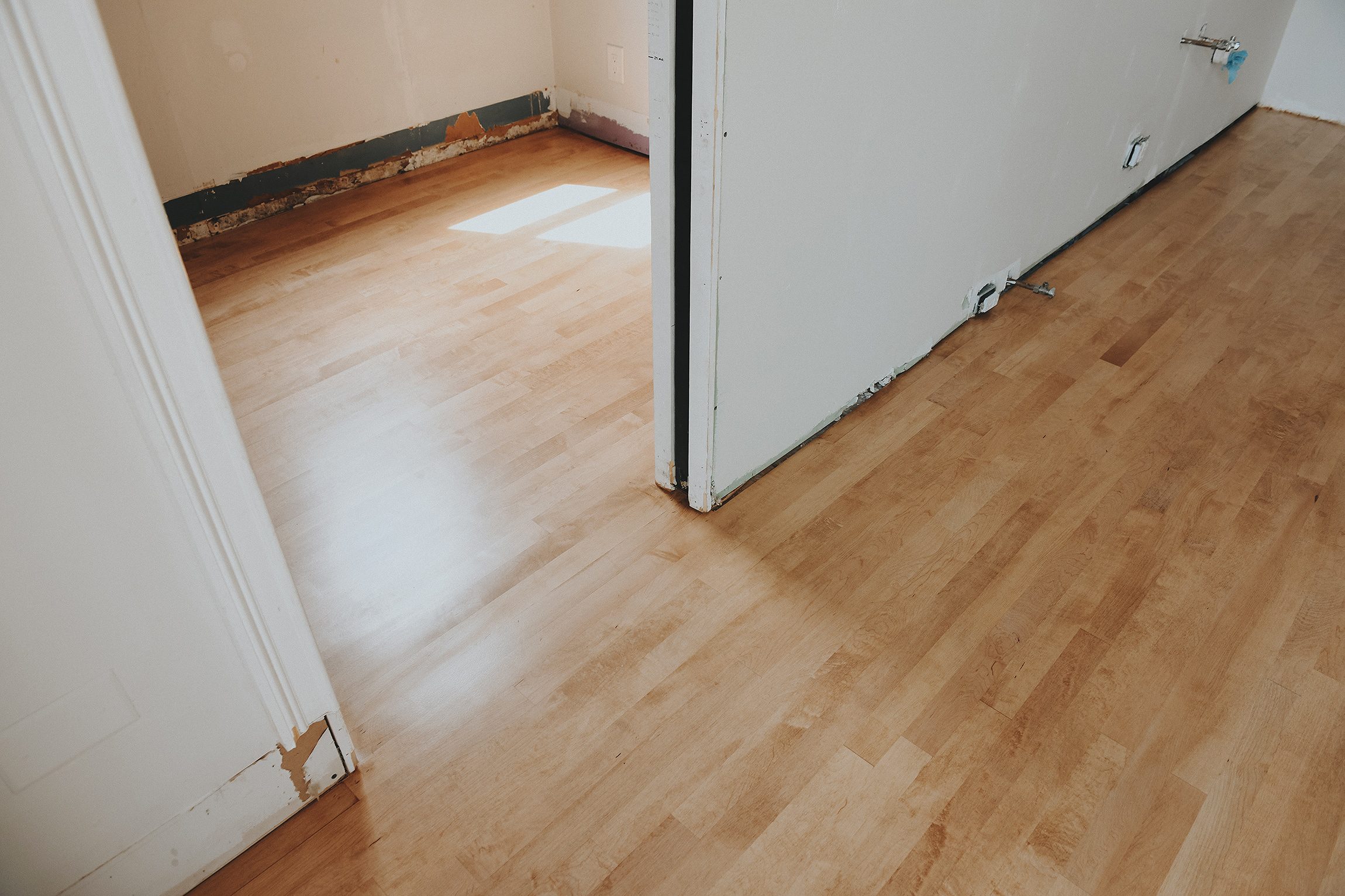 Transition of maple flooring from kitchen to workshop | via Yellow Brick Home