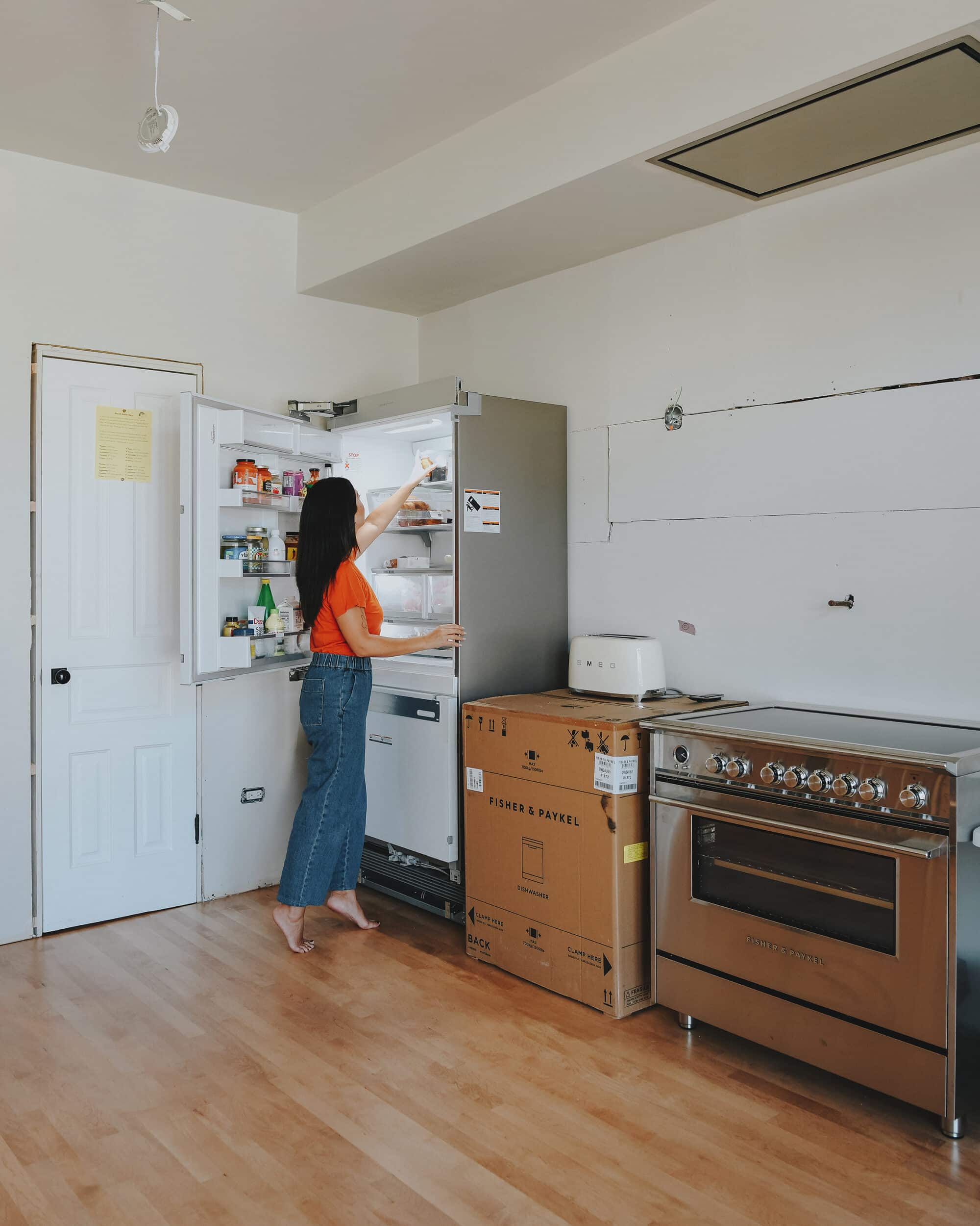 Kim reaches for a drink from our new Fisher & Paykel 80" counter-depth single door refrigerator // via Yellow Brick Home